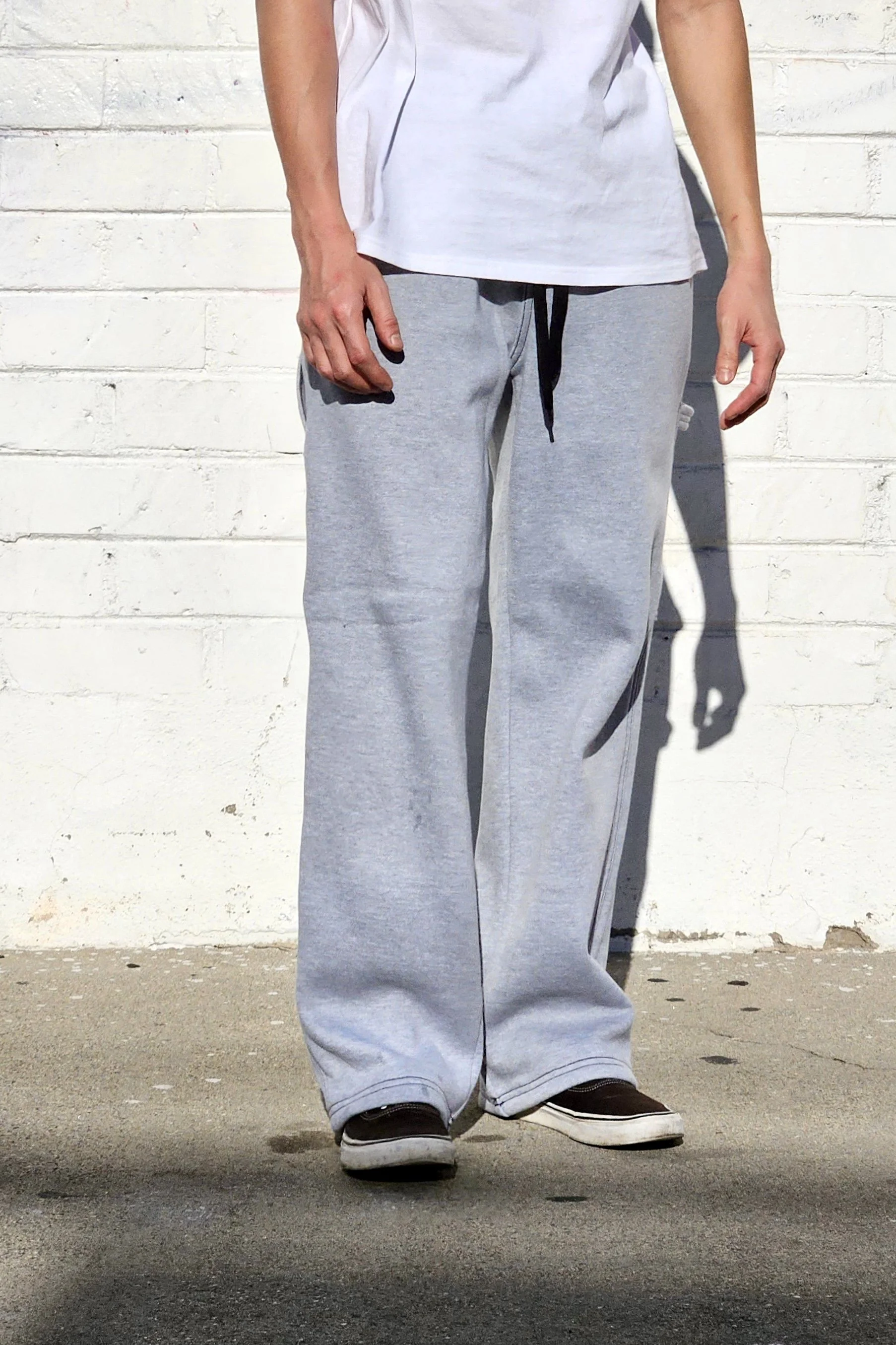 Side view of unisex grey baggy carpenter sweatpants.