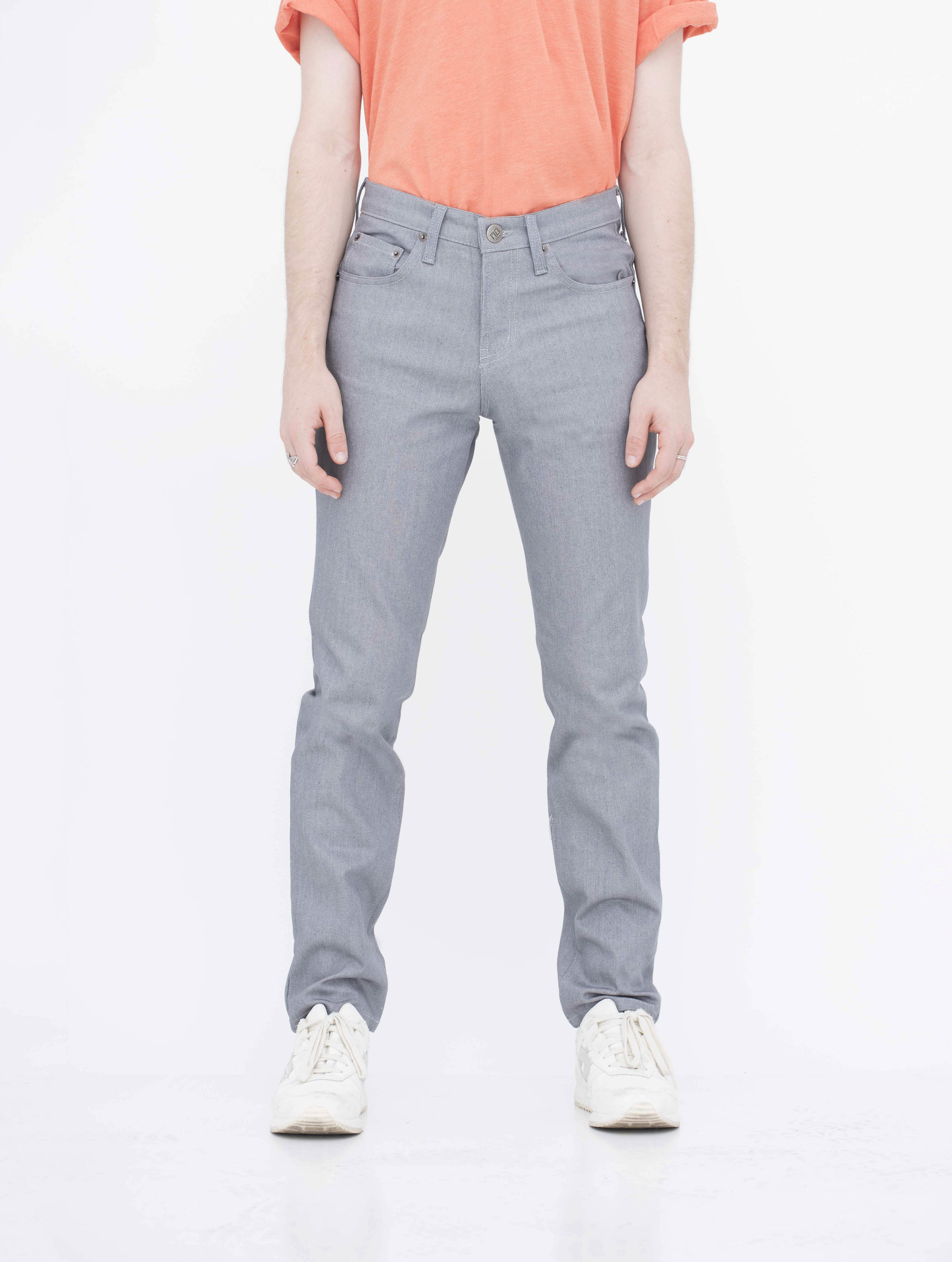 Front view of model in denim light grey jeans.