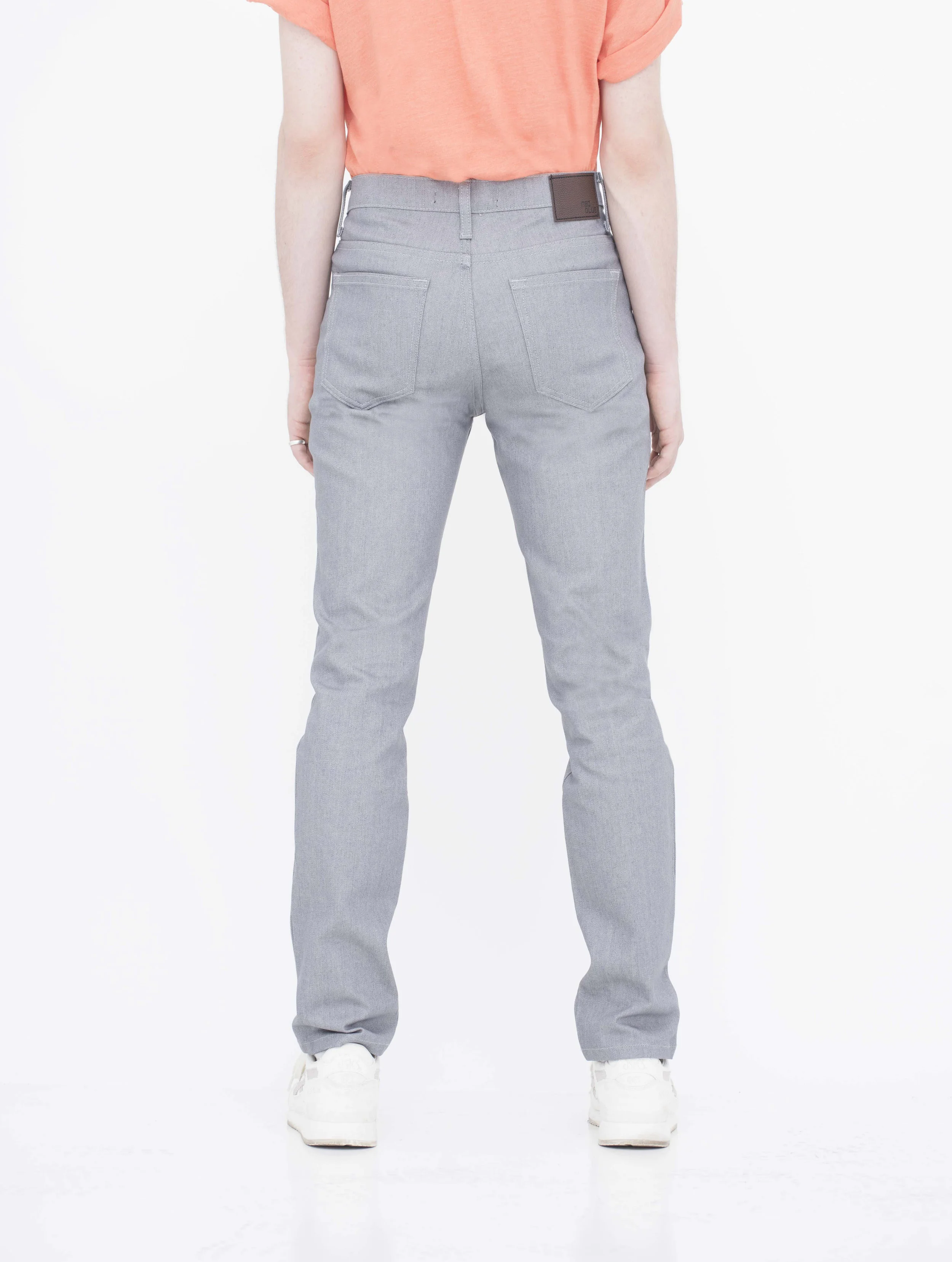 Back view of model in denim light grey jeans.