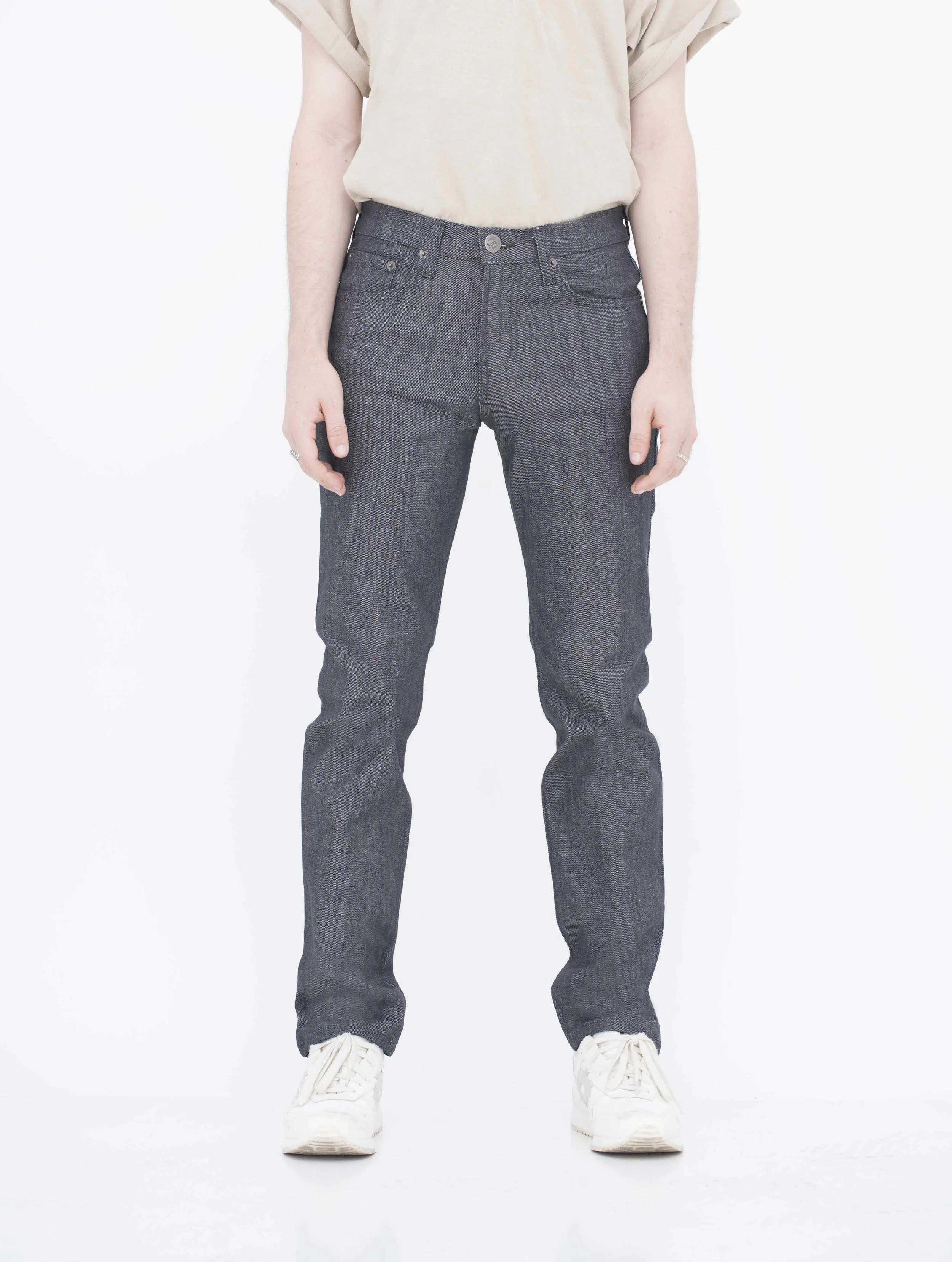 Front view of model in denim charcoal skinny jeans.