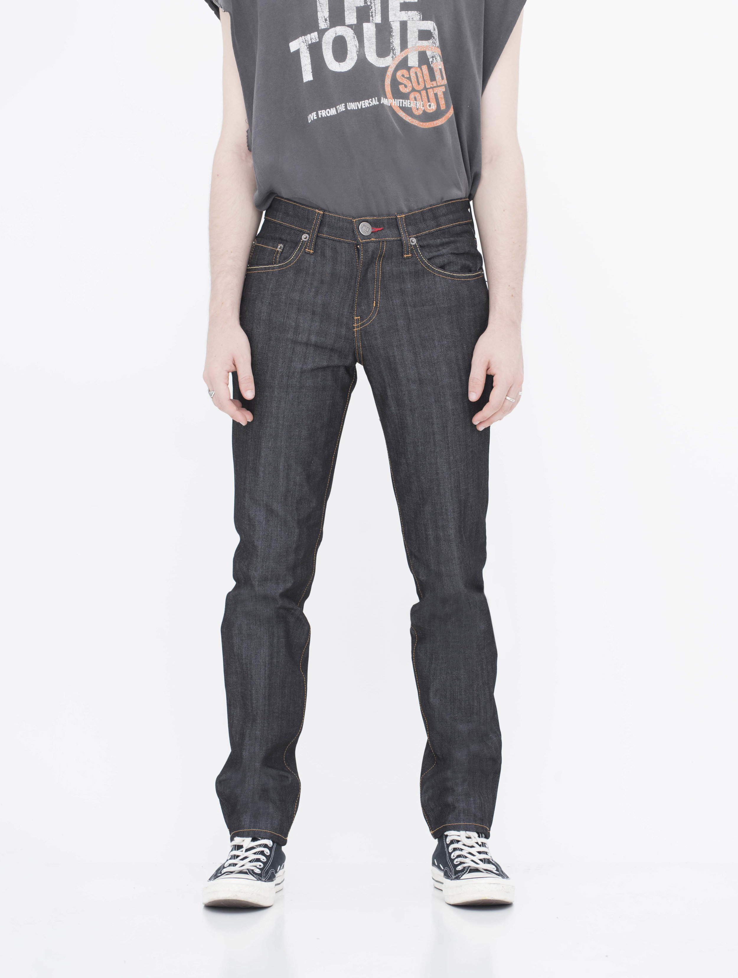 Front view of model indigo black gold stitch skinny jeans.