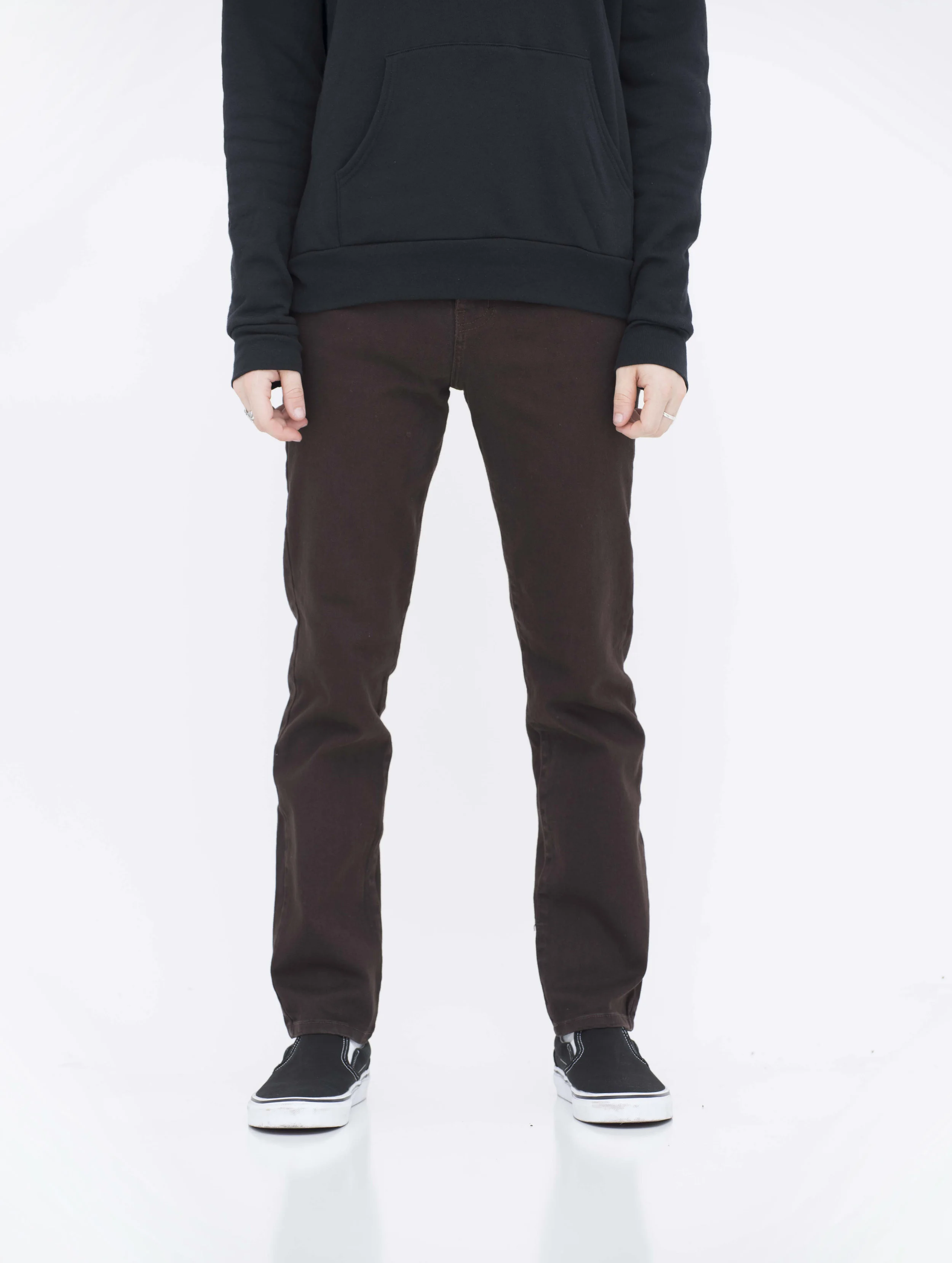 Front view of model in brown skinny jeans.