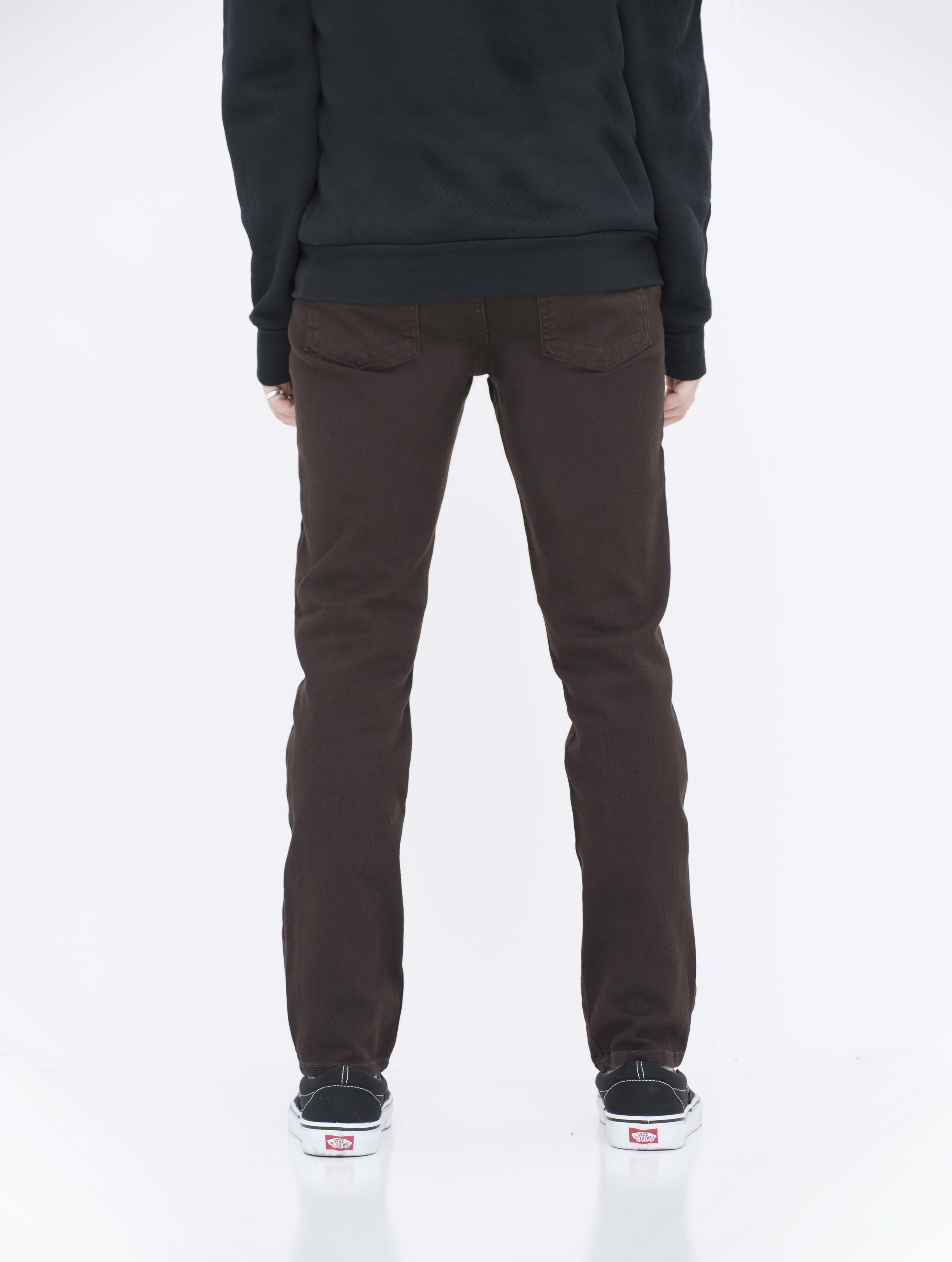 Back view of model in brown skinny jeans.