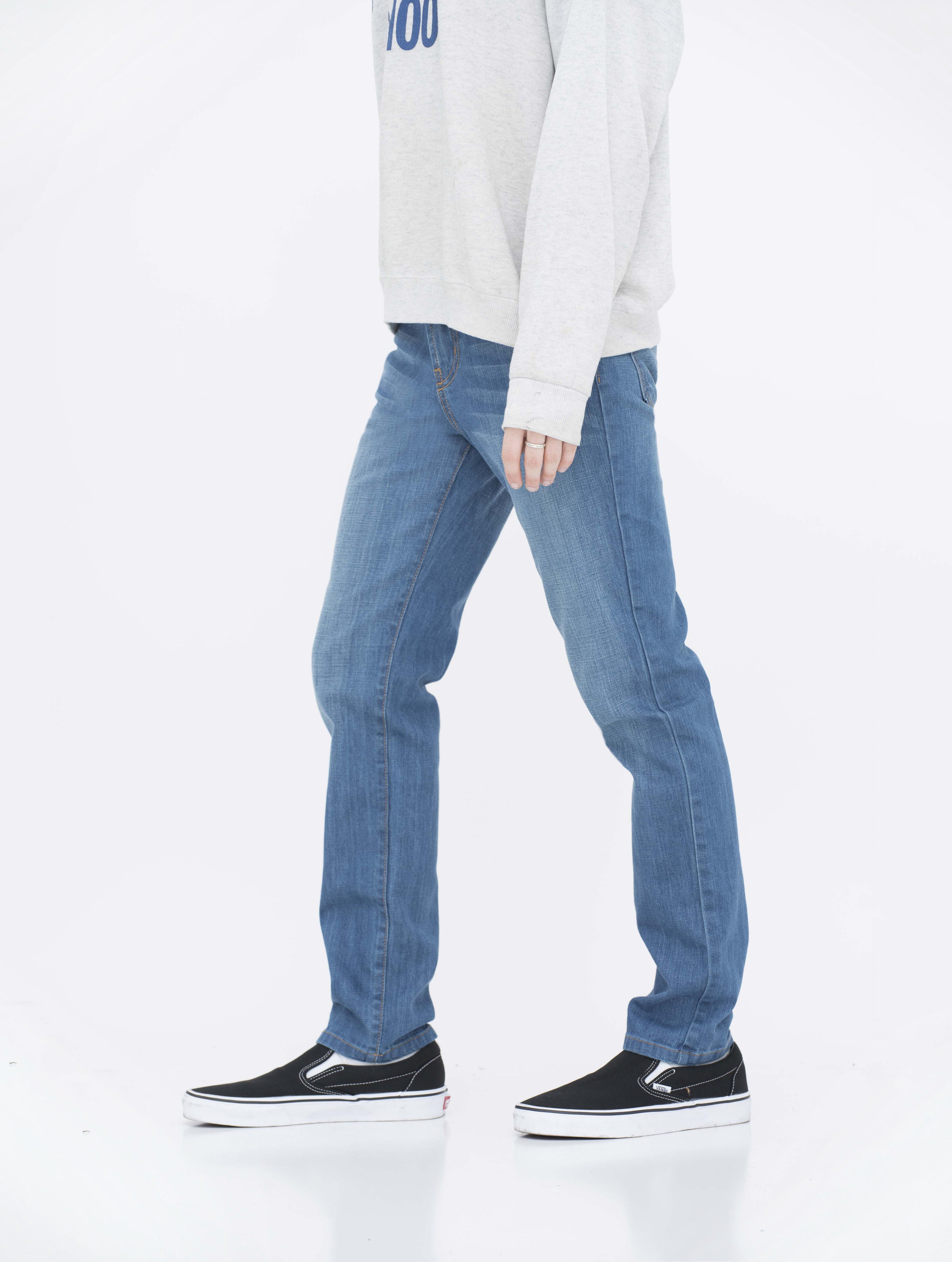 Side view of model in fade medium blue skinny jeans.