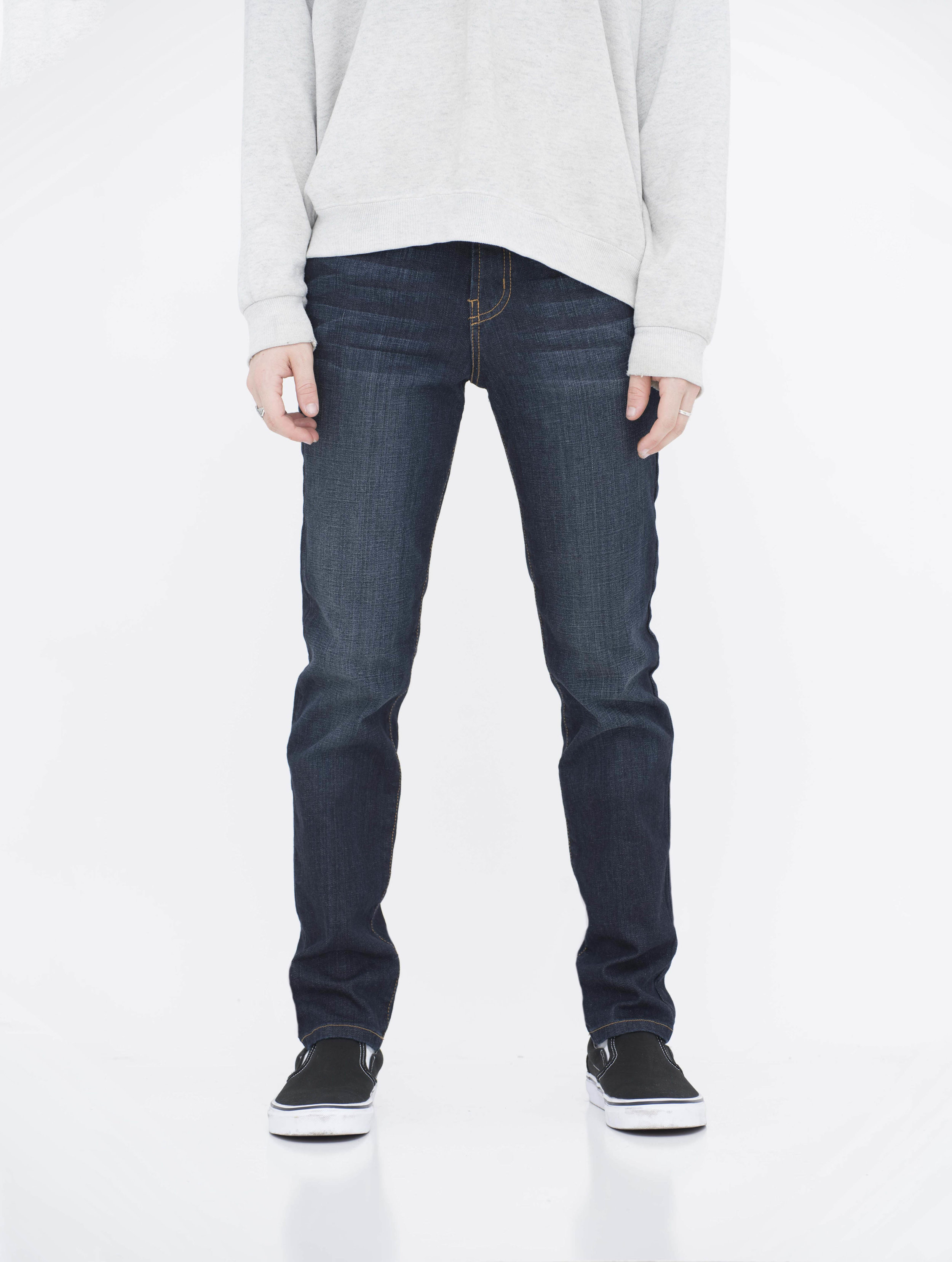 Front view of model in fade super dark neo blue skinny jeans.