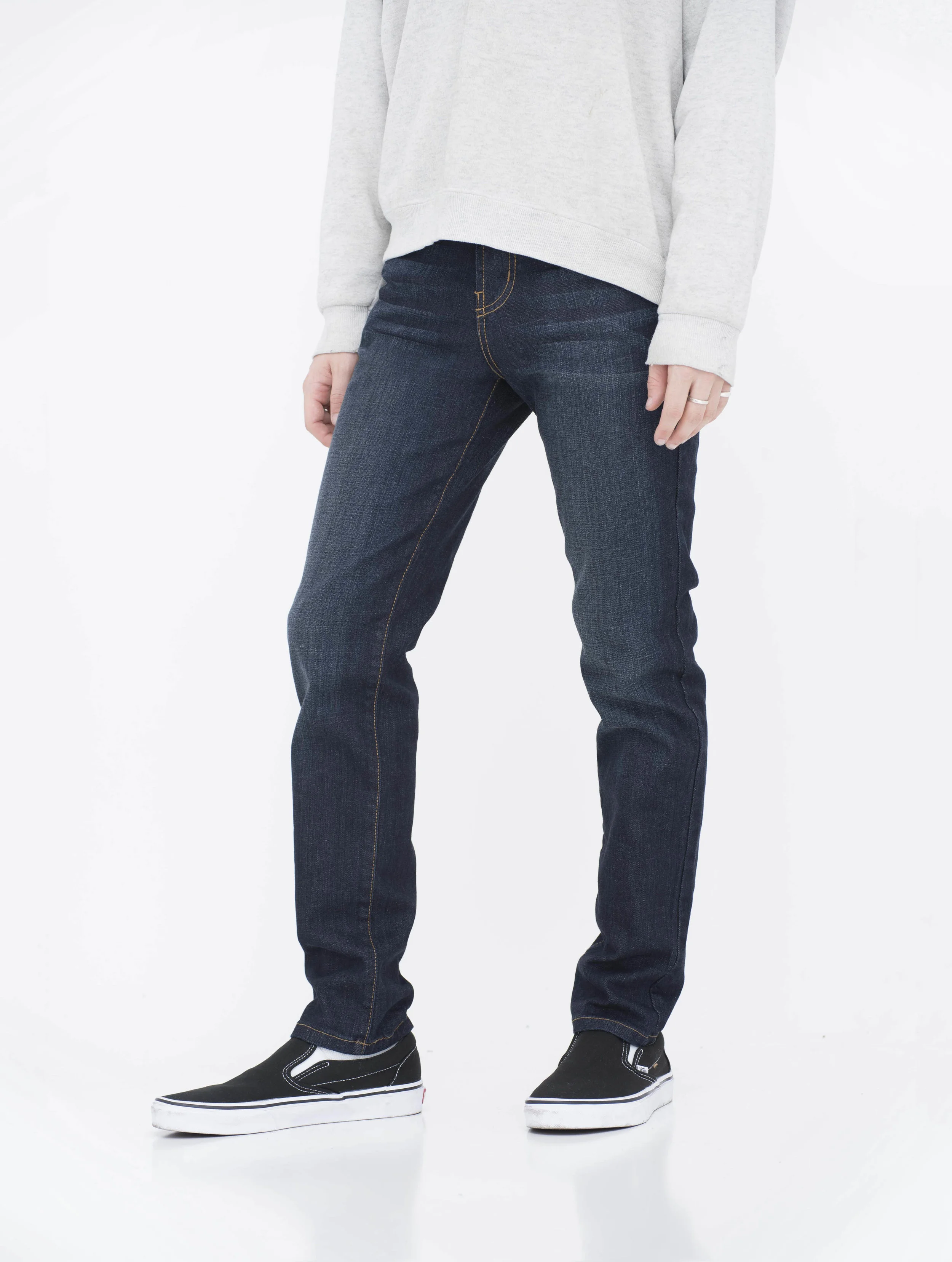 Side view of model in fade super dark skinny jeans.