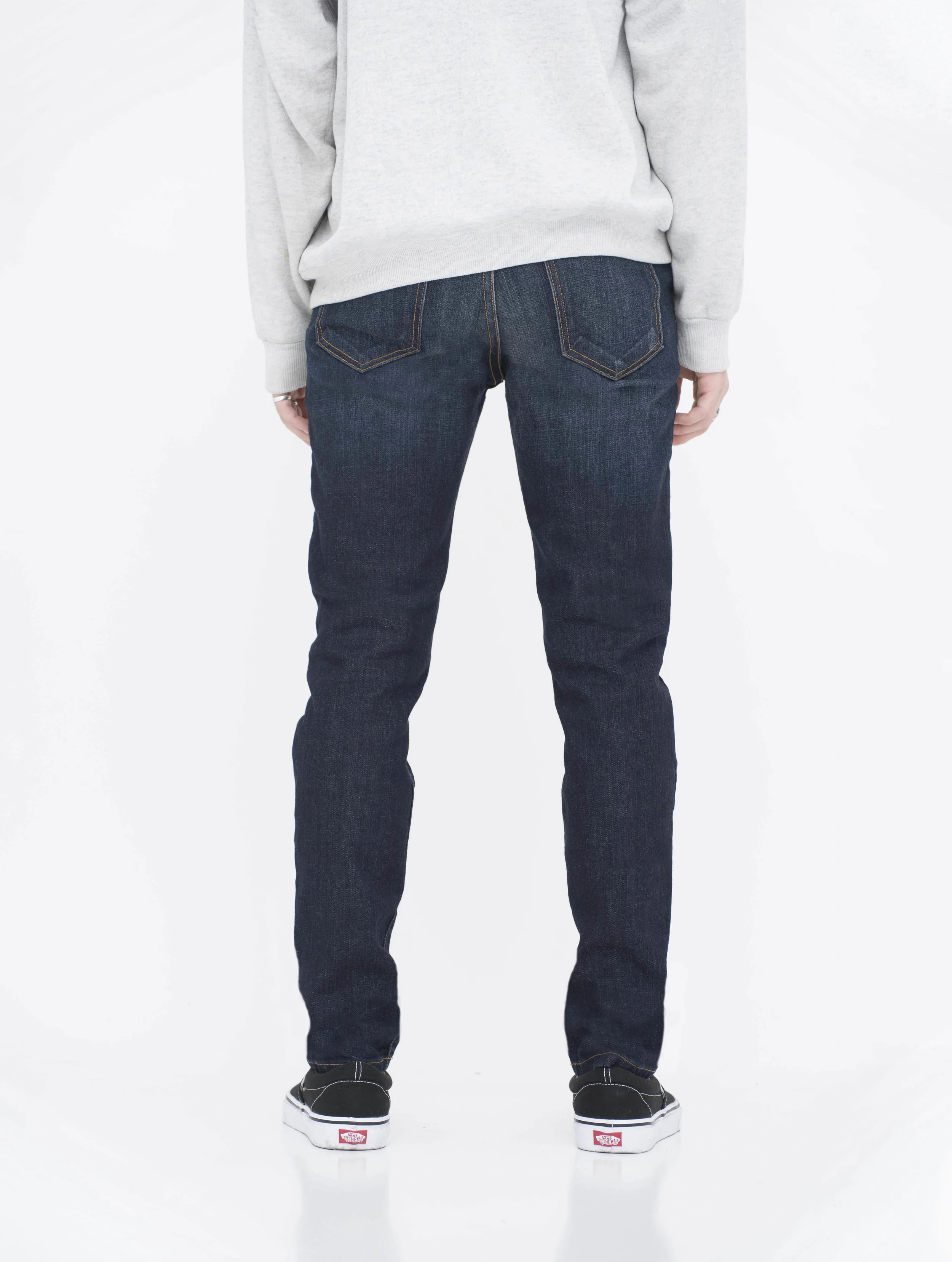 Back view of model in fade super dark skinny jeans.