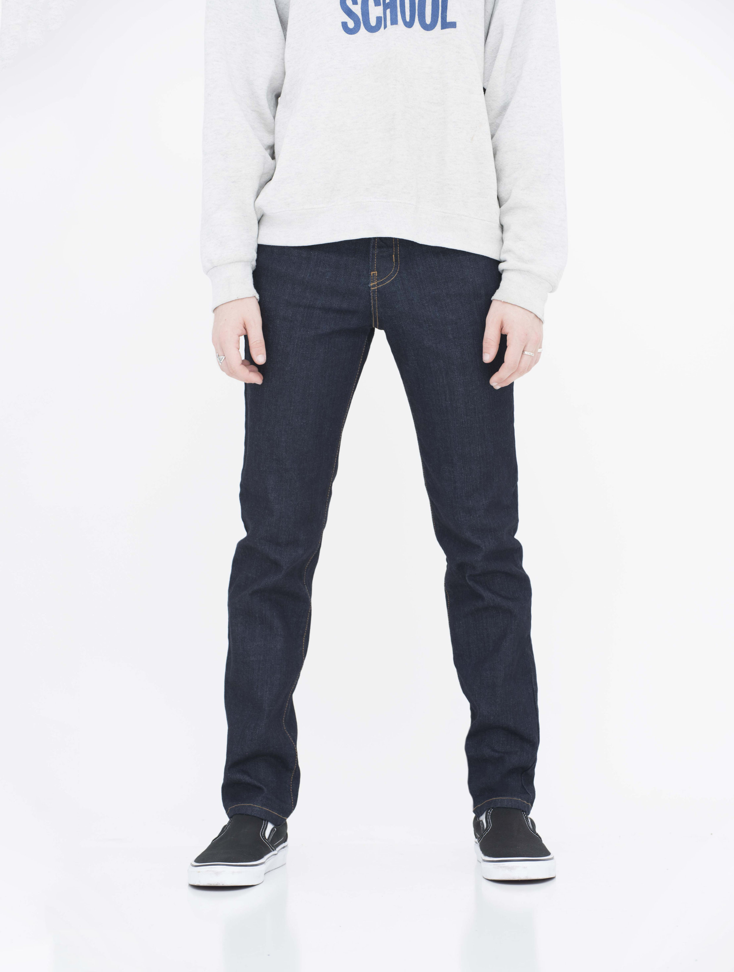 Front view of model in wash super dark skinny jeans.