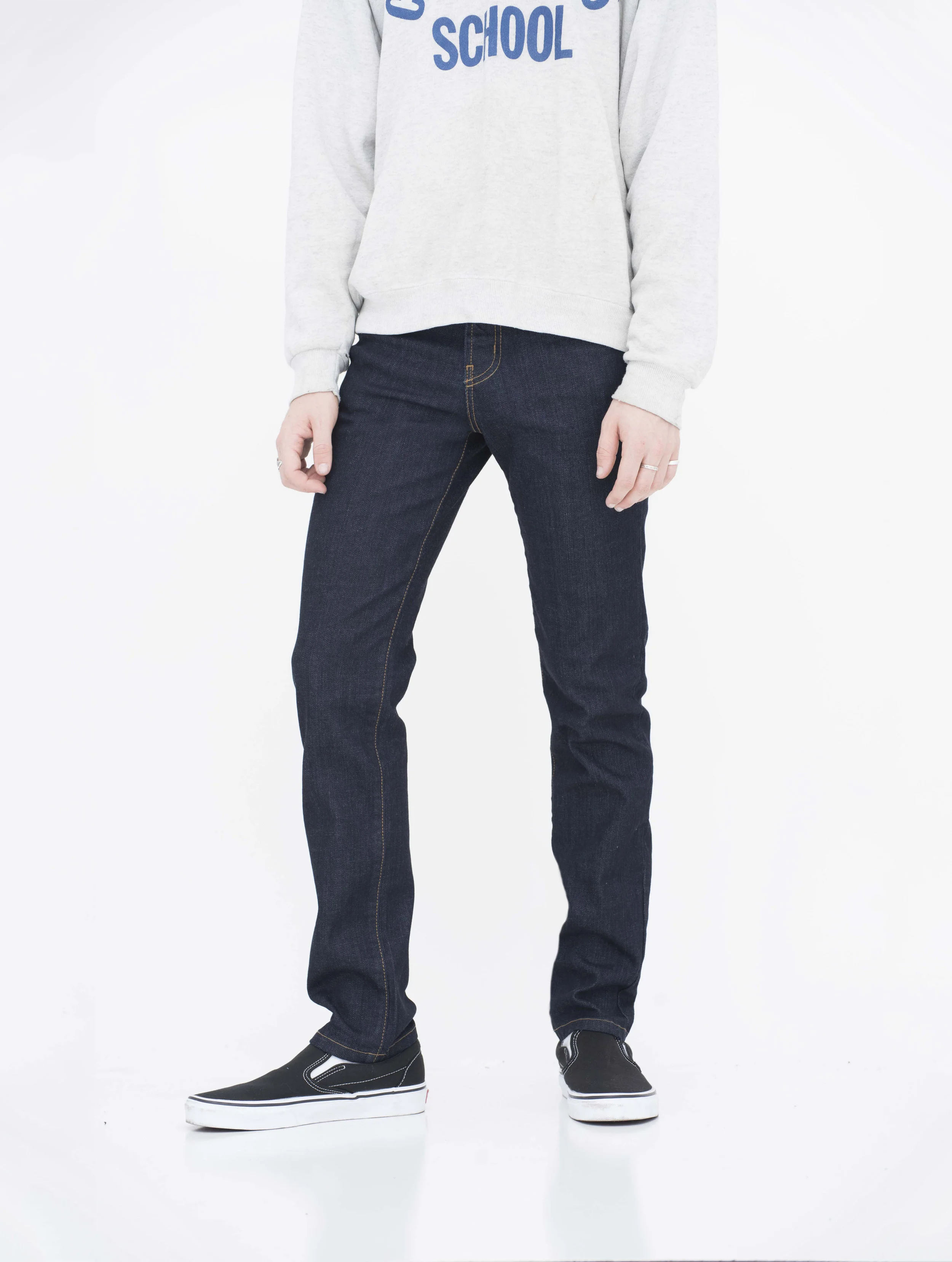 Front view of model in wash super dark skinny jeans.