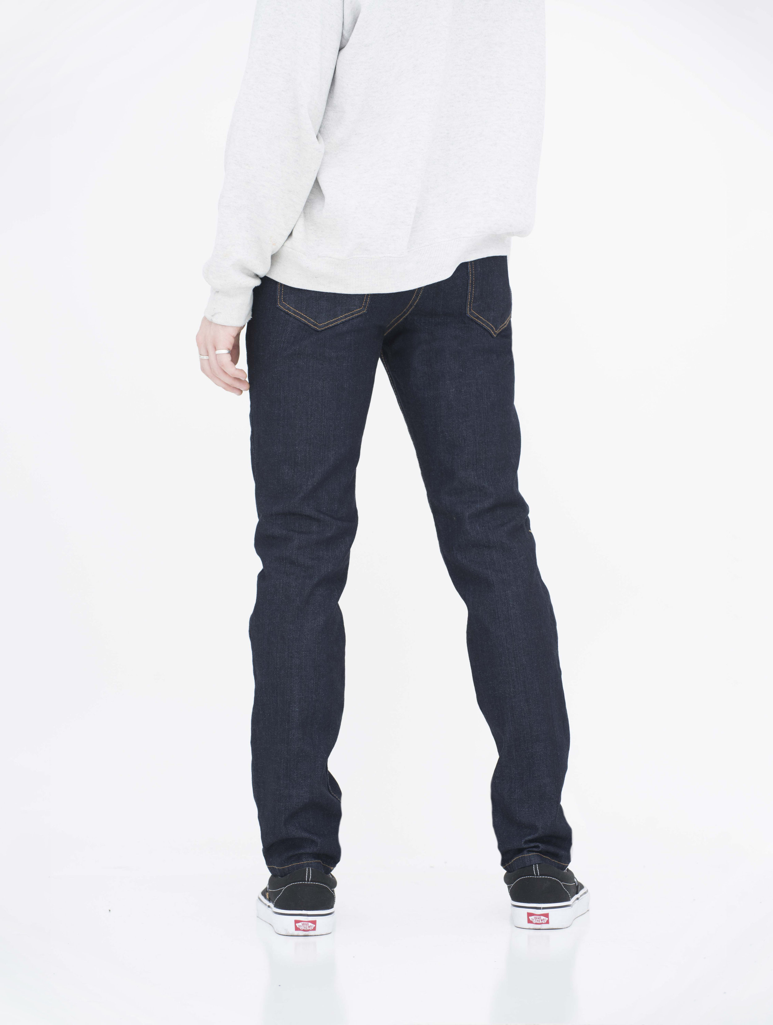 Back view of model in wash super dark skinny jeans.