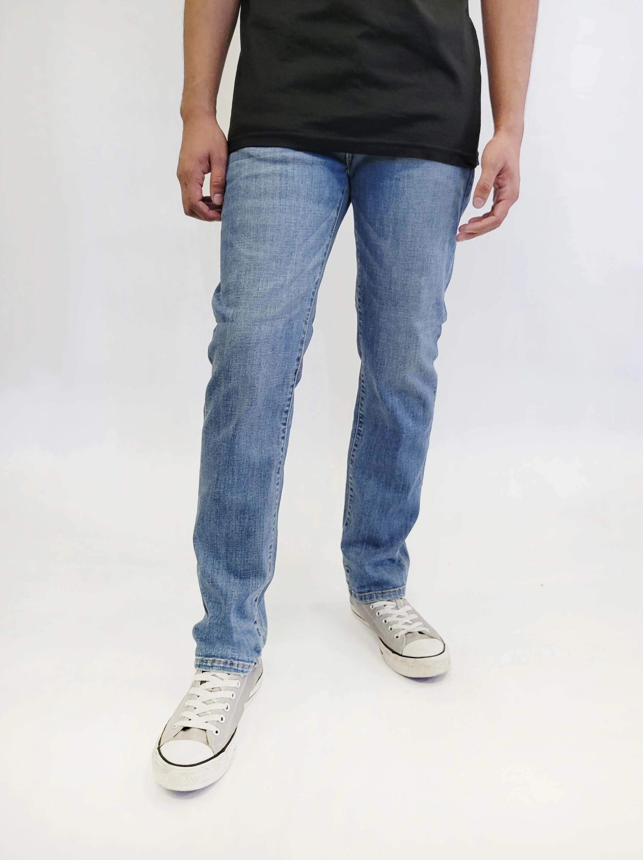 Front view of model in fade medium blue slim straight jeans.