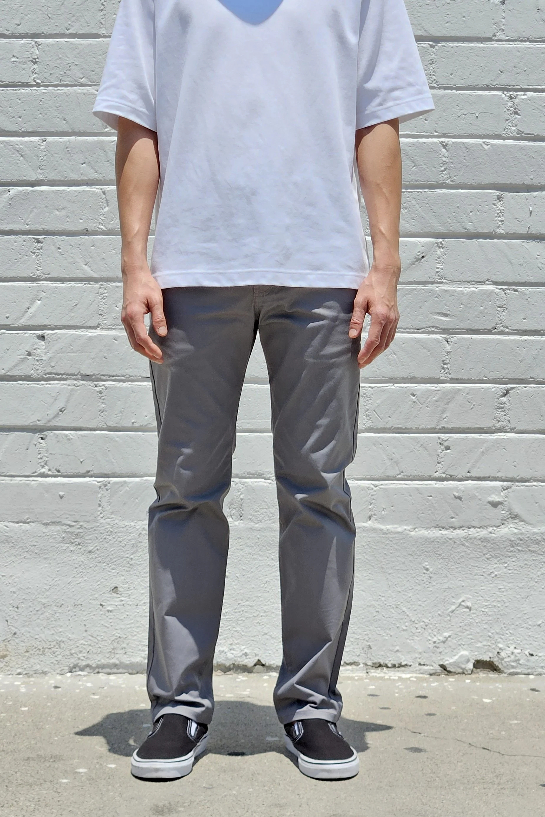 Front view of model in men’s chino grey pants.