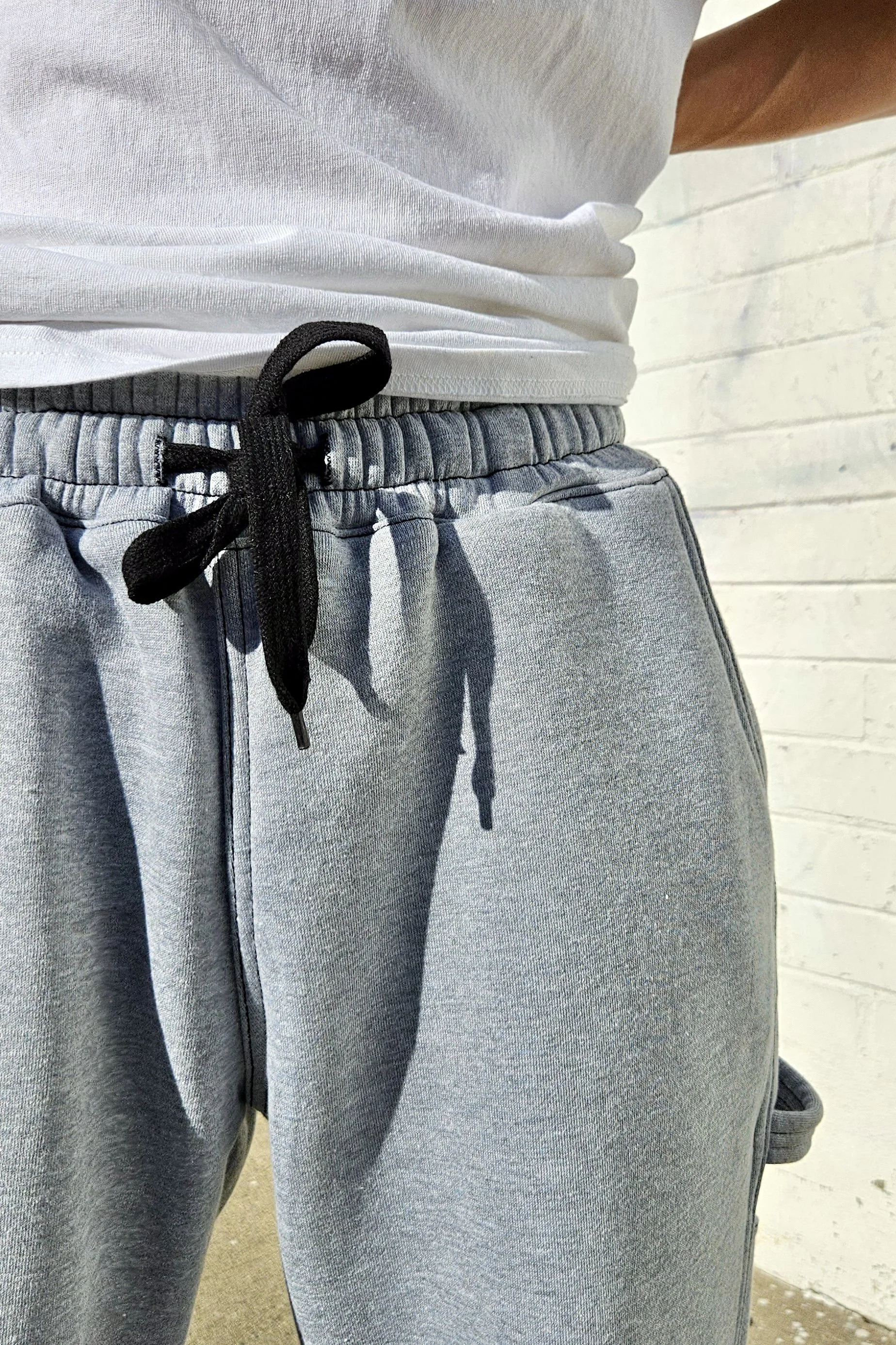 Close up front view of unisex grey baggy carpenter sweatpants.