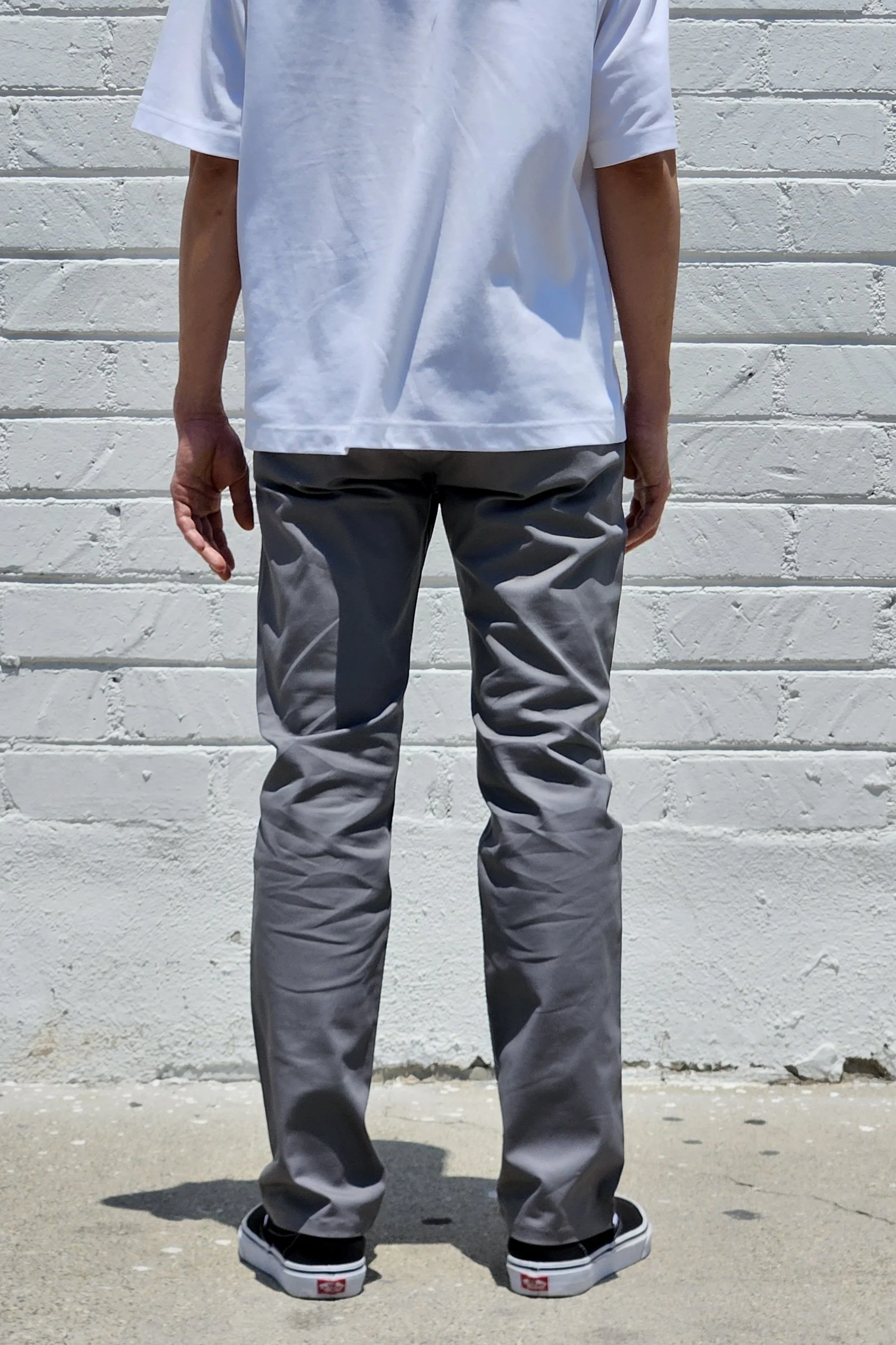 Back view of model in men’s chino grey pants.
