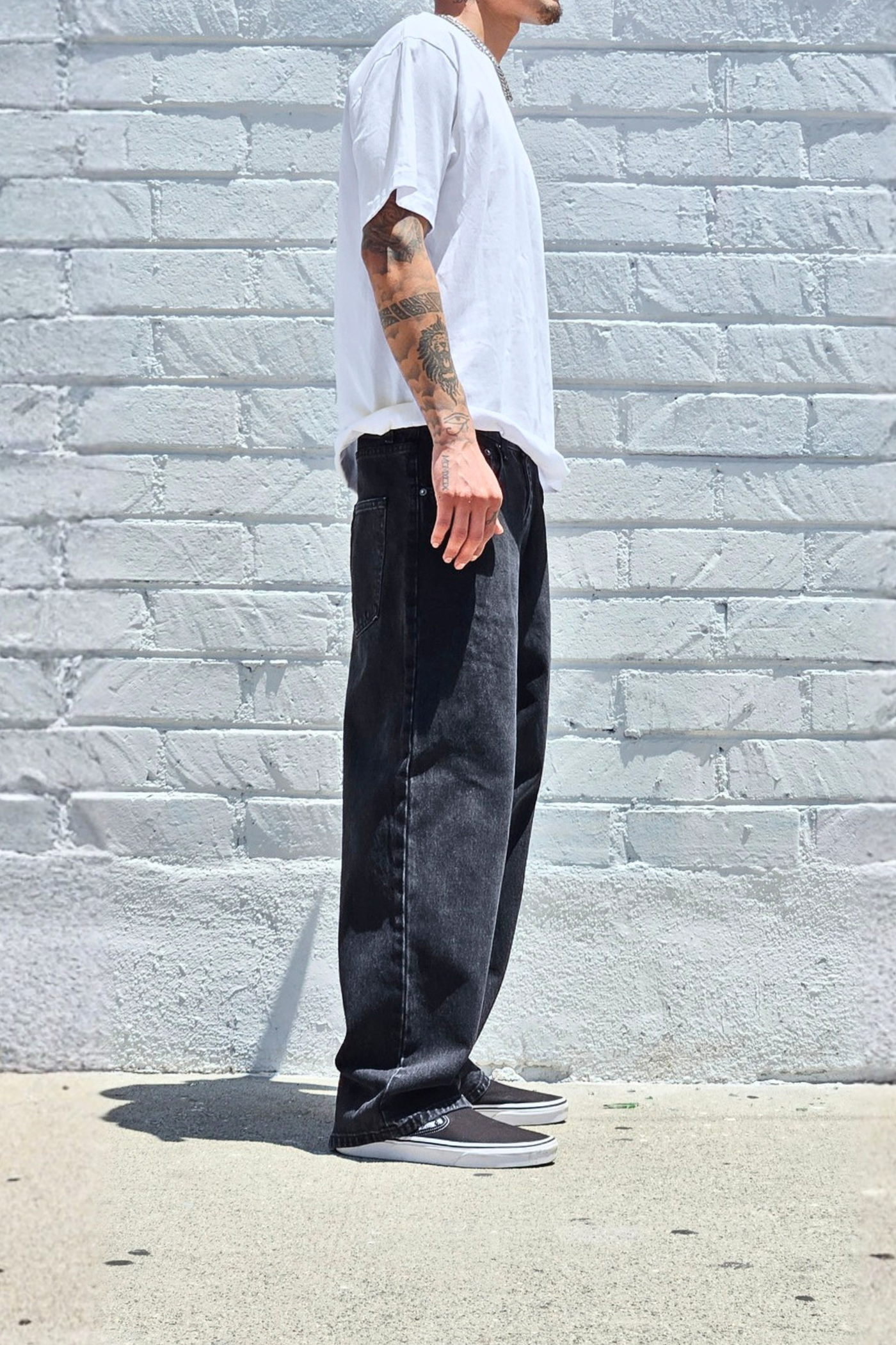 Men's loose fit black denim jeans with a casual baggy silhouette.