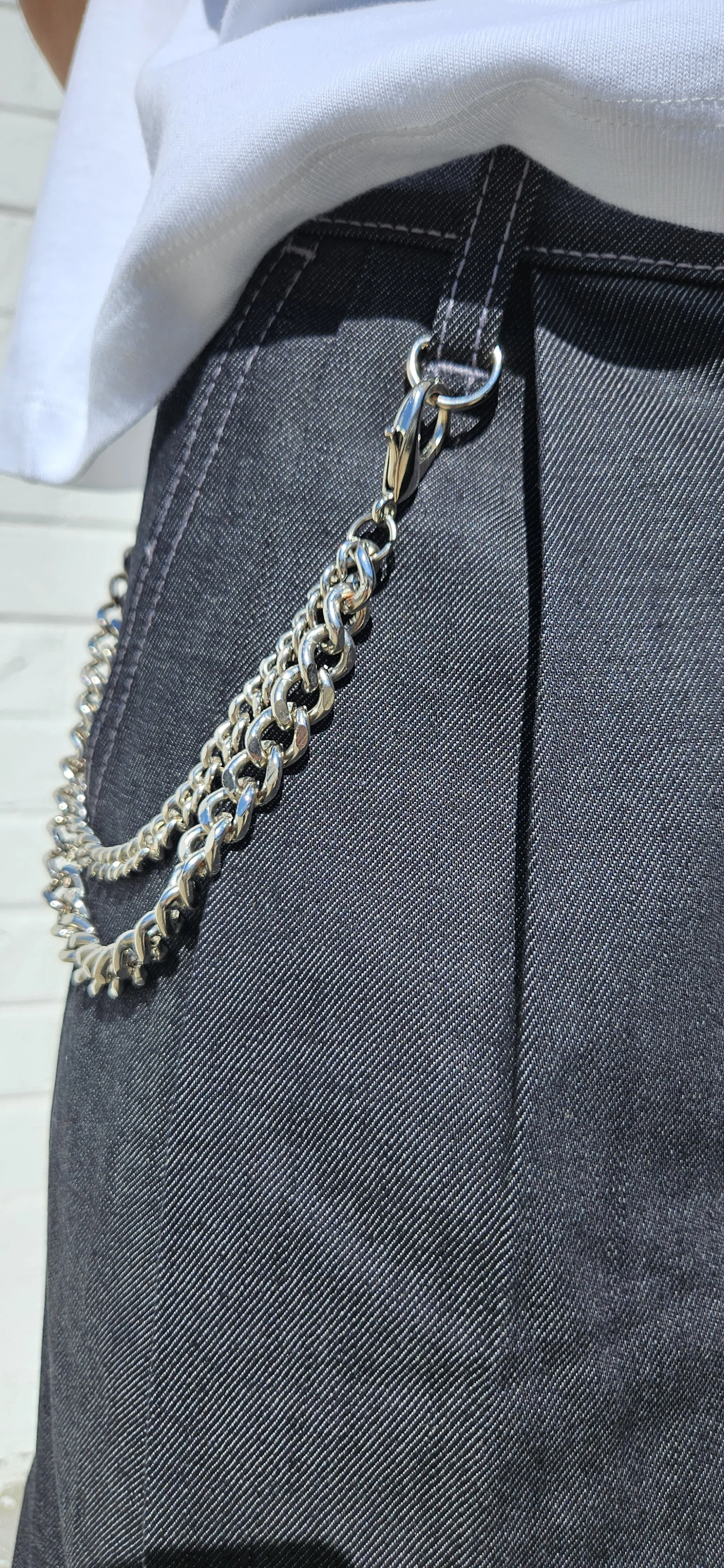 Front close up view of denim charcoal double pleated baggy jean short with d-ring hook