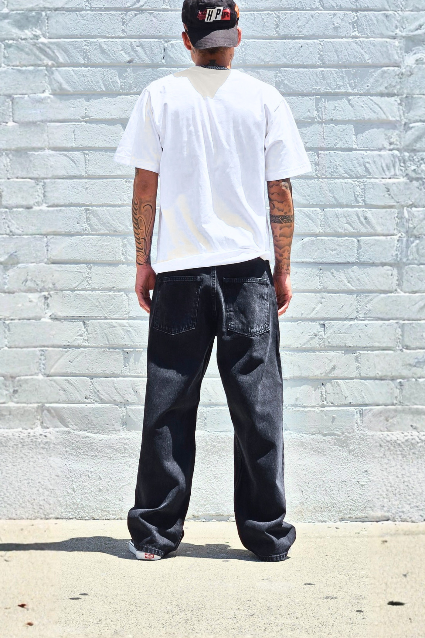 Men's vintage black baggy jeans styled for an everyday streetwear look.