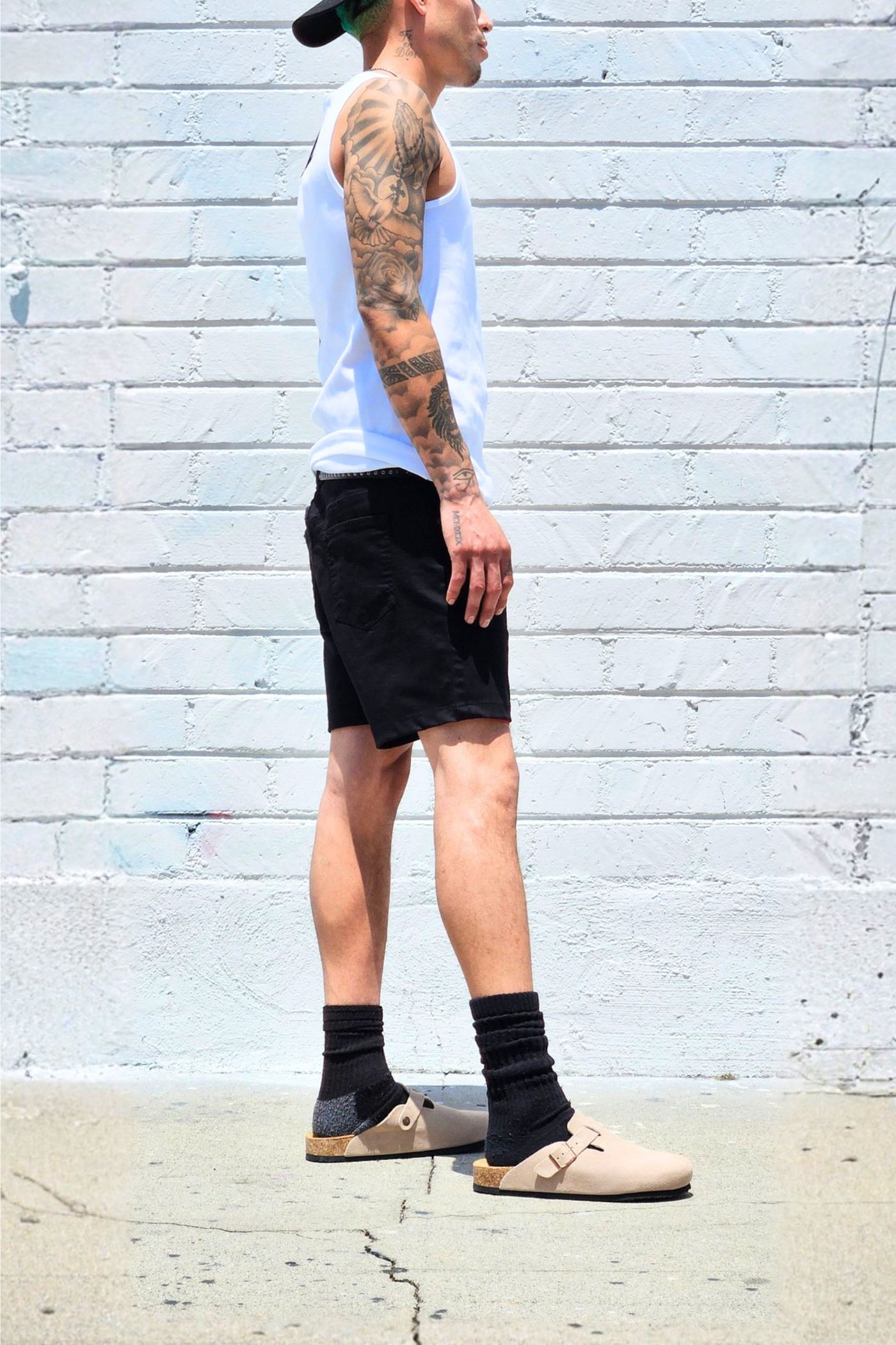 Black summer shorts styled for casual streetwear outfits.