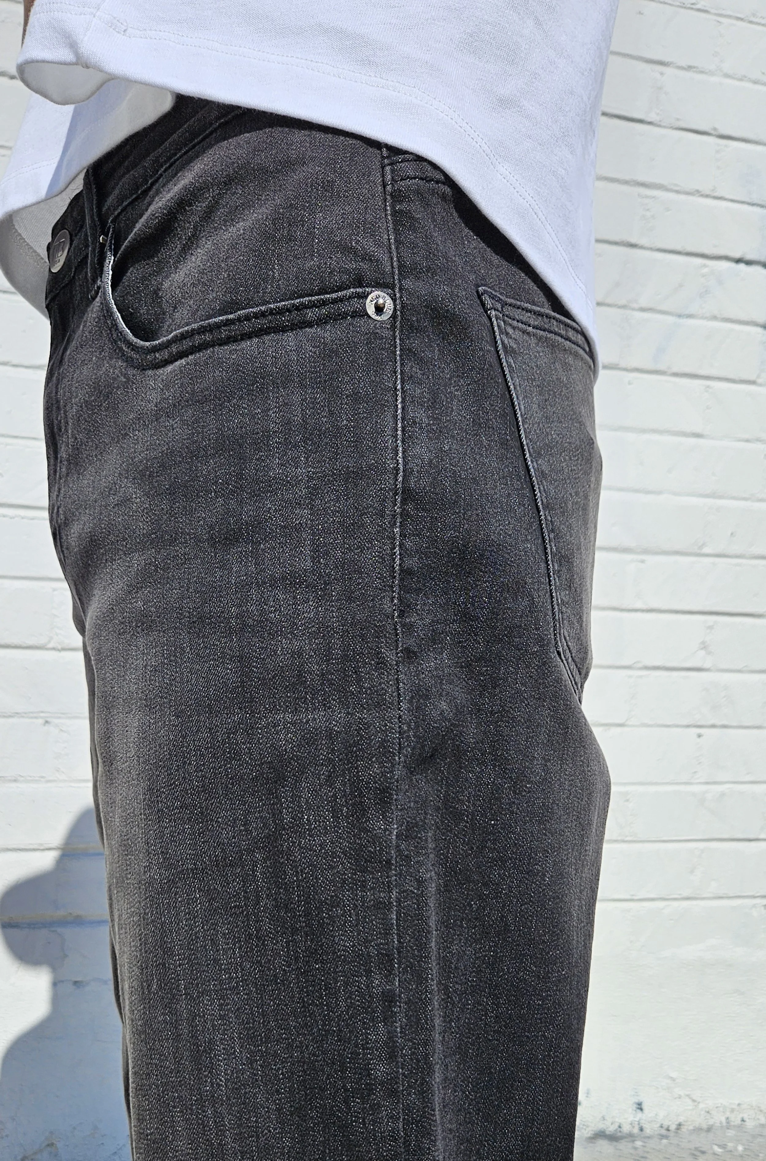 Pocket detail view in fade black 90s fit relaxed straight jeans.