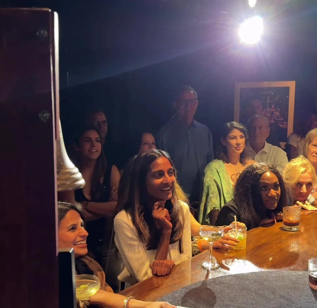 Guests leaning in around the Library Bar during HUBB's close-up sleight of hand