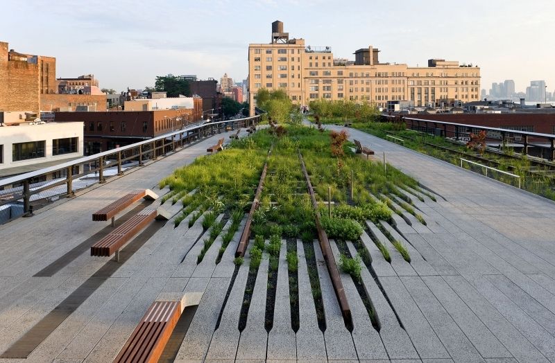 Greenfield development: Two women chat on a patch of grass along the High Line. (Julie Jacobson/AP Photo)
