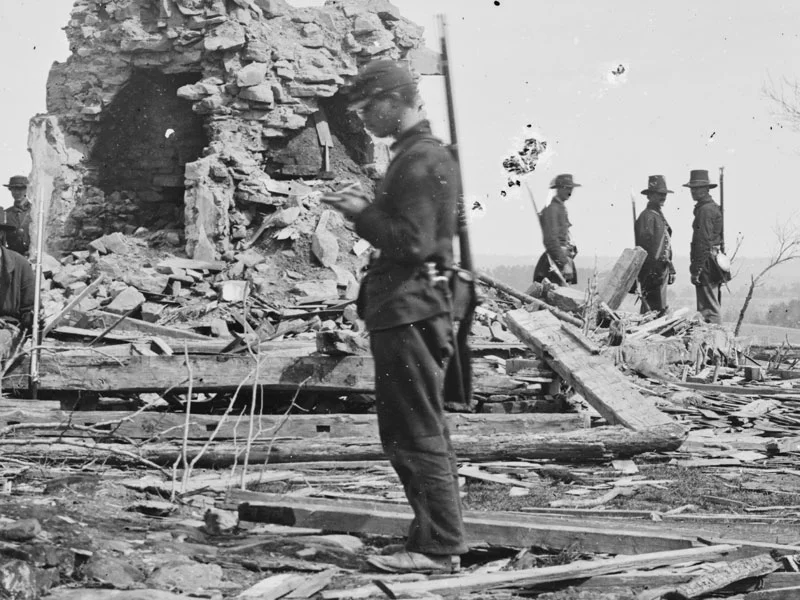 March, 1862. The man in the foreground is wearing dark blue trousers, while others in the background wear light blue. (LOC#: LC-B811-320)