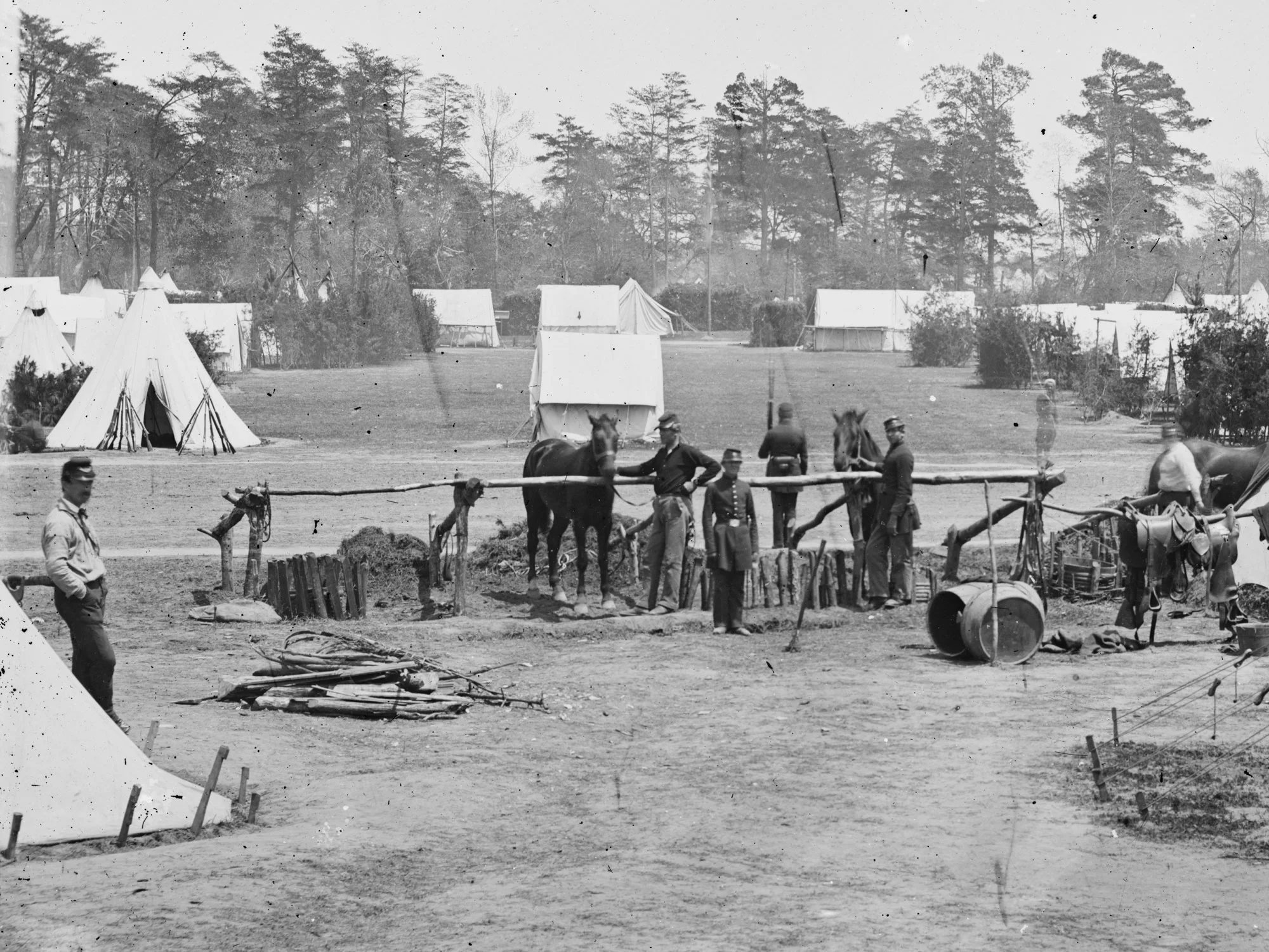 May, 1862. HQ of Gen. George B. McClellan, Camp Winfield Scott, near Yorktown, Va. Five men are seen wearing dark blues - including the man sitting by the rifle stacks at the left edge of the photo. (LOC#: LC-B811-367A)
