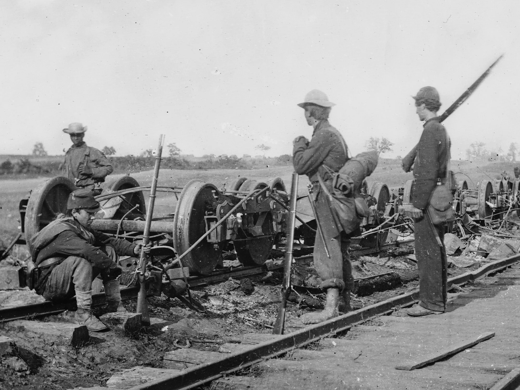 August, 1862. Soldiers beside damaged rolling stock of the Orange & Alexandria Railroad, near Manassas Junction, Va. One of my personal favorite photos, it shows a mix of the man on the right wearing dark blues, with the other two wearing sky blues. (LOC#: LC-B815-593)