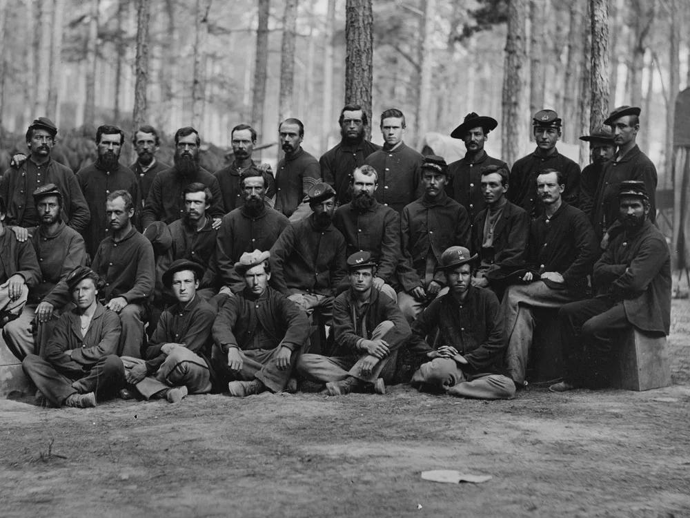 August, 1864 "Essayons Dramatic Club," a group of the U.S. Engineer Battalion, near Petersburg, Va. Two men in this photo are wearing dark blues. (LOC#: LC-B817-7336)