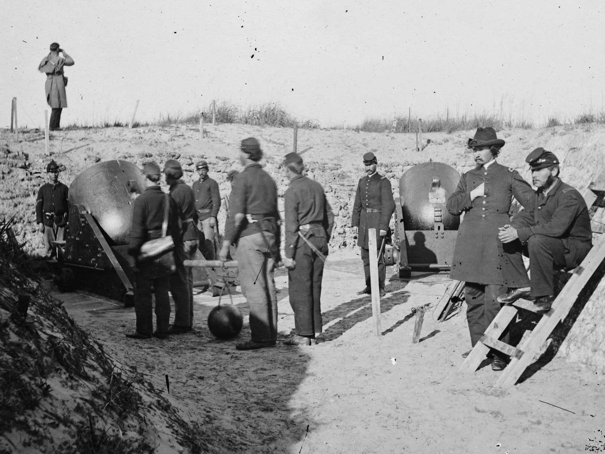 1865 An enlisted man in a mortar crew at Morris Island, SC opposing Ft. Sumter wears dark blue trousers. (LOC#: LC-B811-3513)