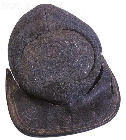 A typical Richmond Clothing Bureau kepi made of blue grey wool with a machine bound oilcloth brim