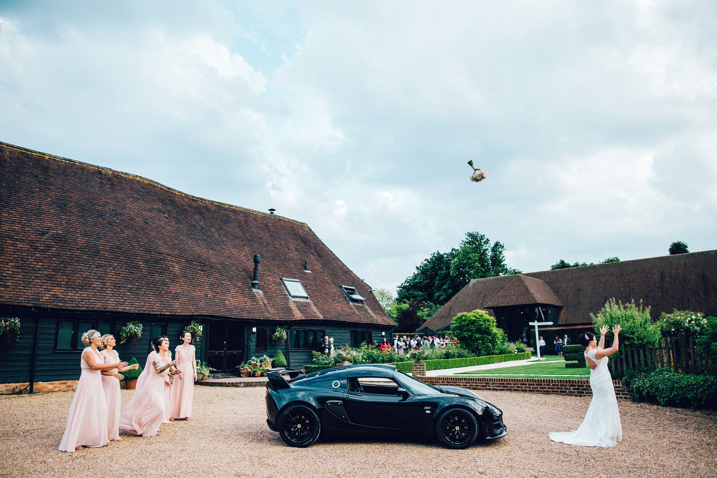 Bouquet throwing over a sports car!