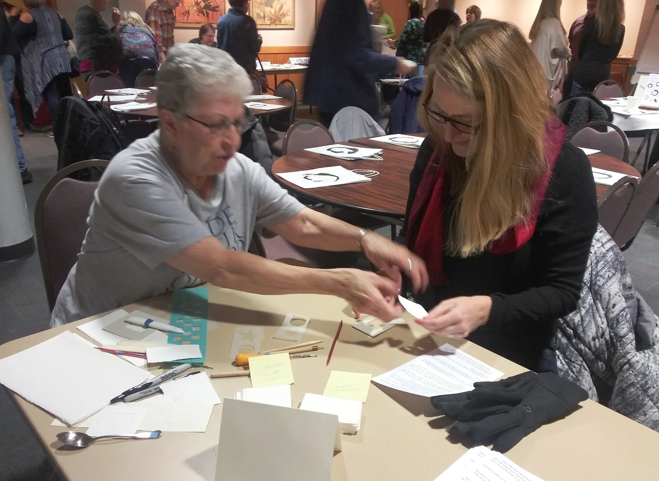 In the Demo Corner, Barb Makela shows Marion Greene an embossing technique she called “Mini Art in a Minit.”