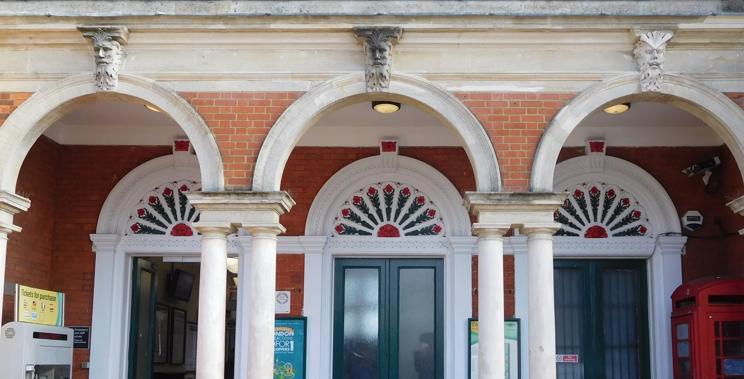 Faces above the three entrance arches of North Dulwich station