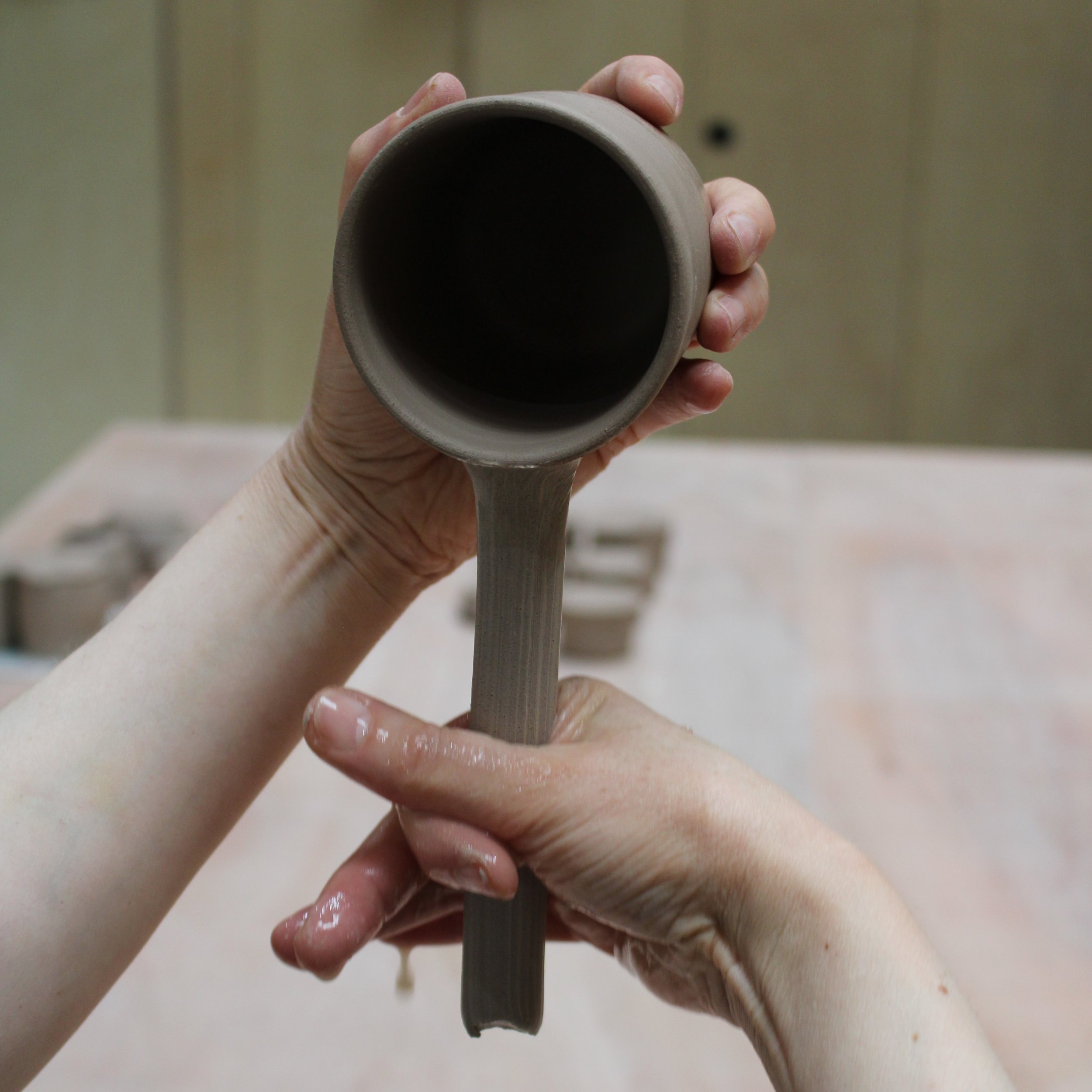 Wheel-thrown mugs and jugs with pulled handles