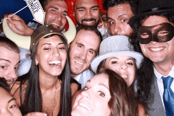 A large group of friends crowding together and wearing party hats and viking props for the 4-hour Party Box Deluxe photo booth package in Portland.