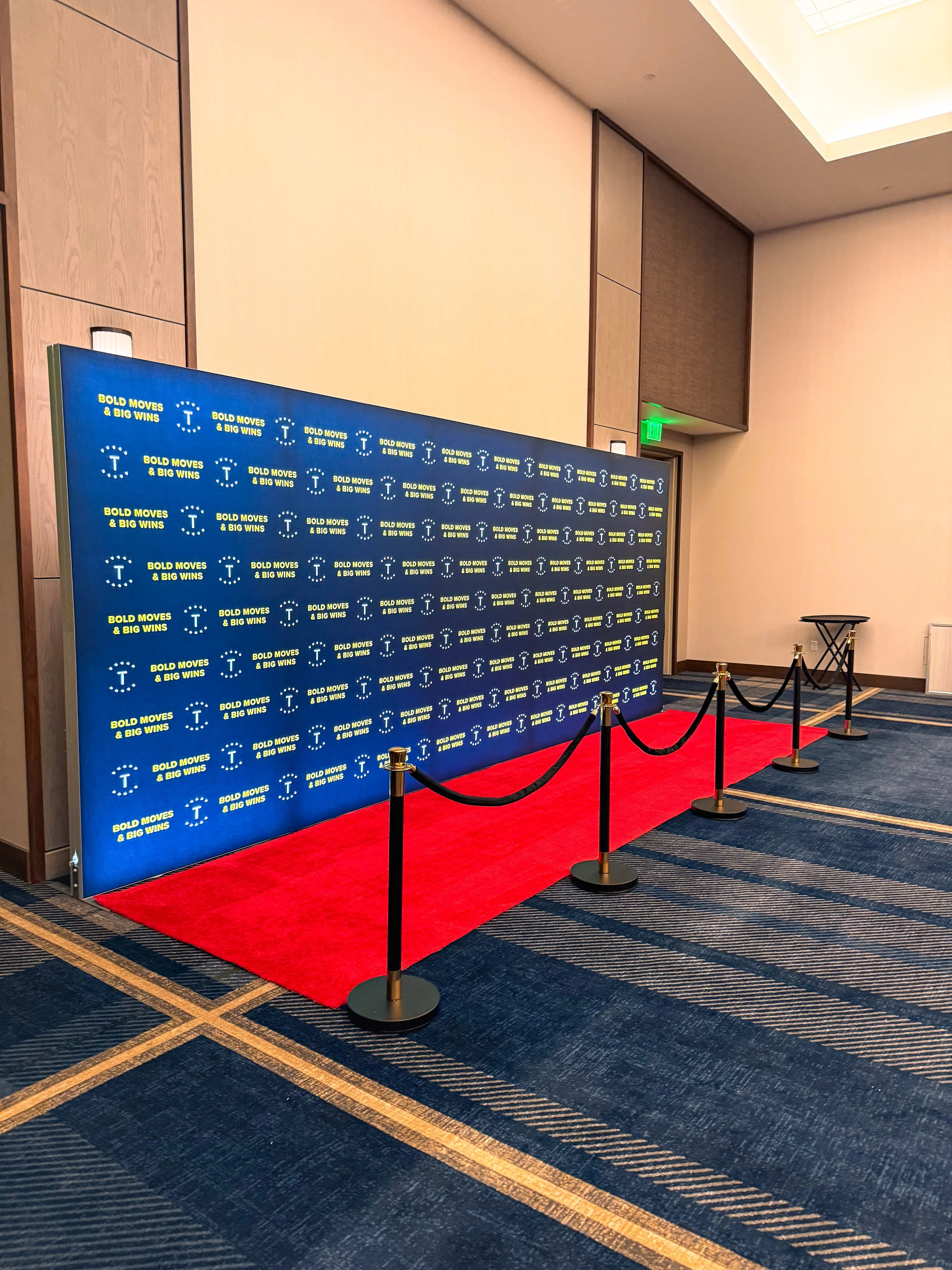 Red carpet step-and-repeat backdrop set up for a Portland corporate awards event