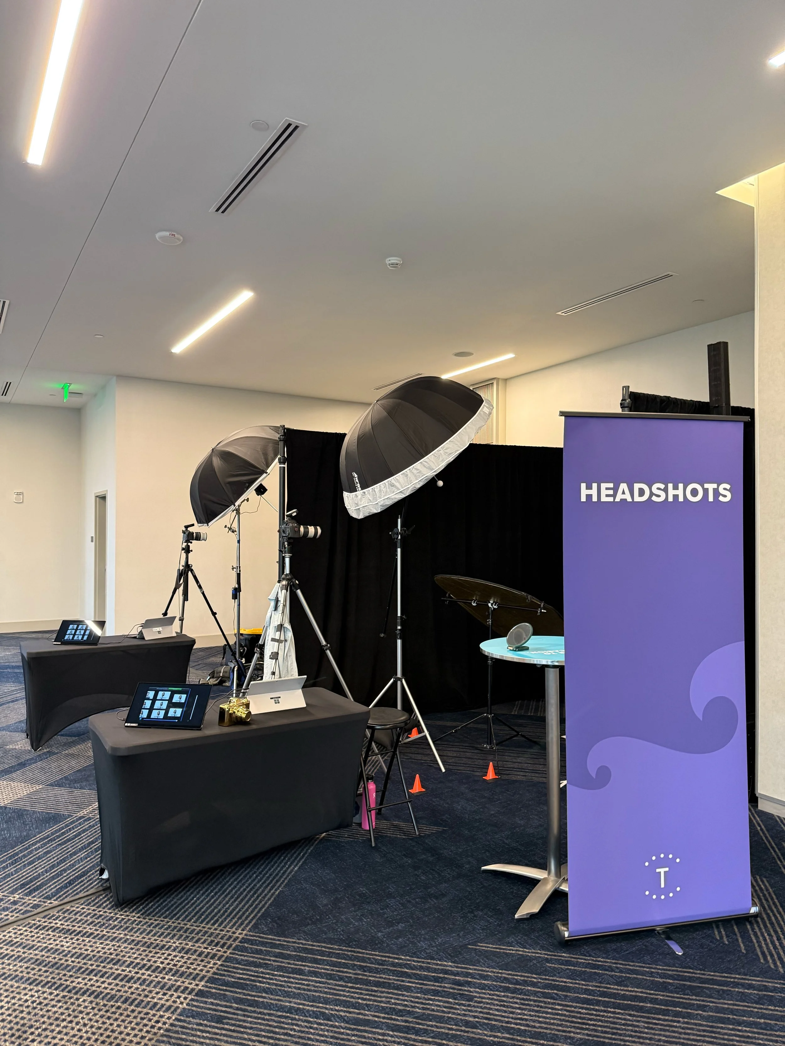 Corporate headshot station with instant sharing kiosks and a headshot banner