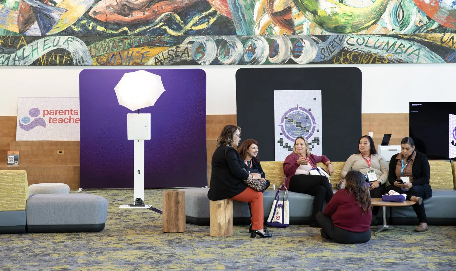 teachers gather by the photo mosaic wall at the Oregon convention center for PATCON26