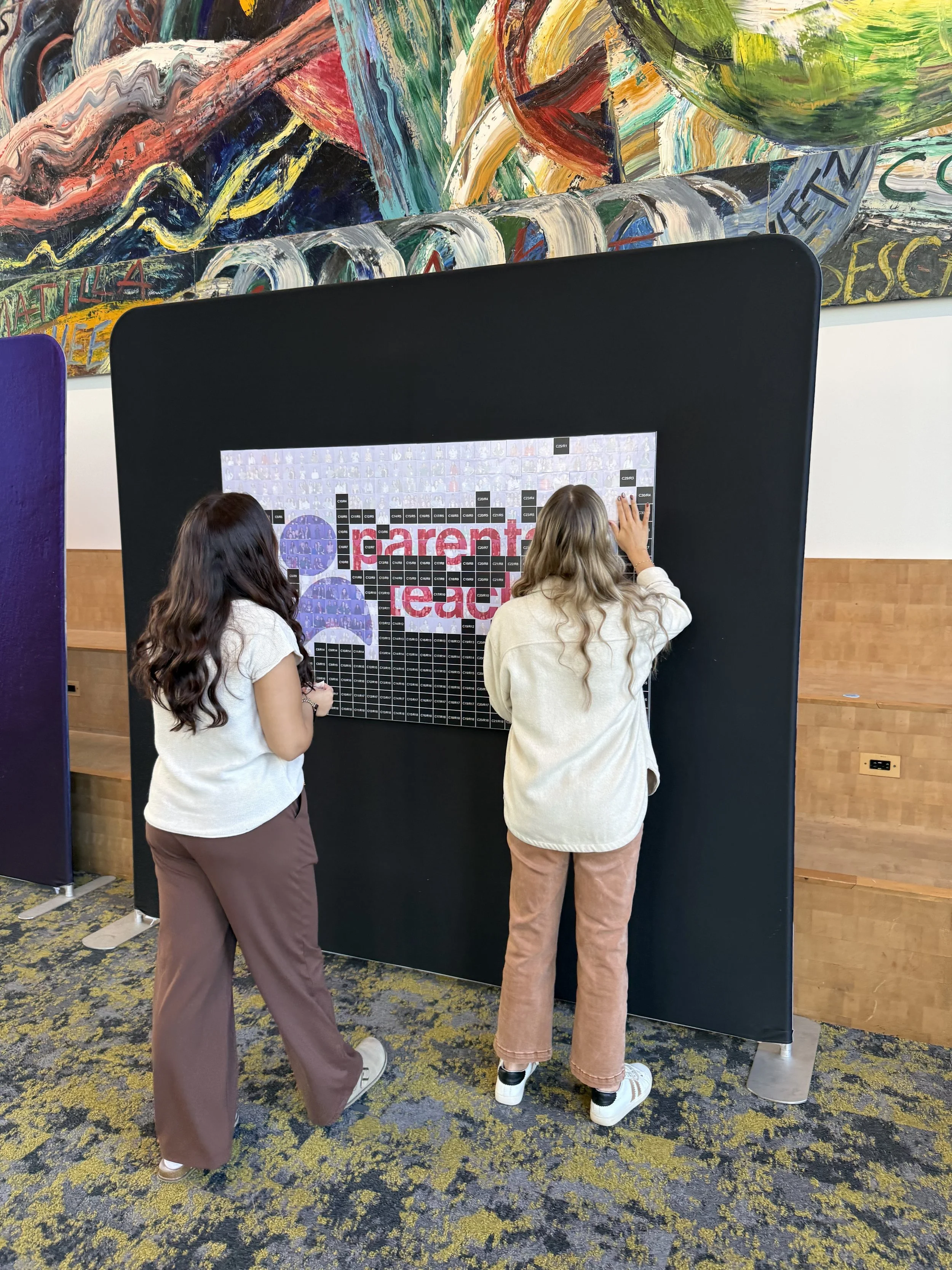 • Conference attendees placing photo tiles on a mosaic at PATCON26