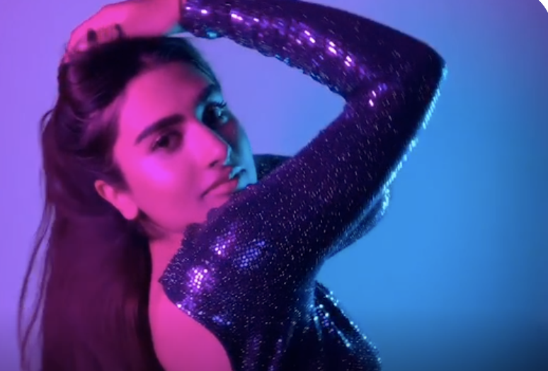 A woman in a purple sequin dress posing under vibrant colored LED lighting for the 3-hour Salsa Photo Booth Plus package in Portland.