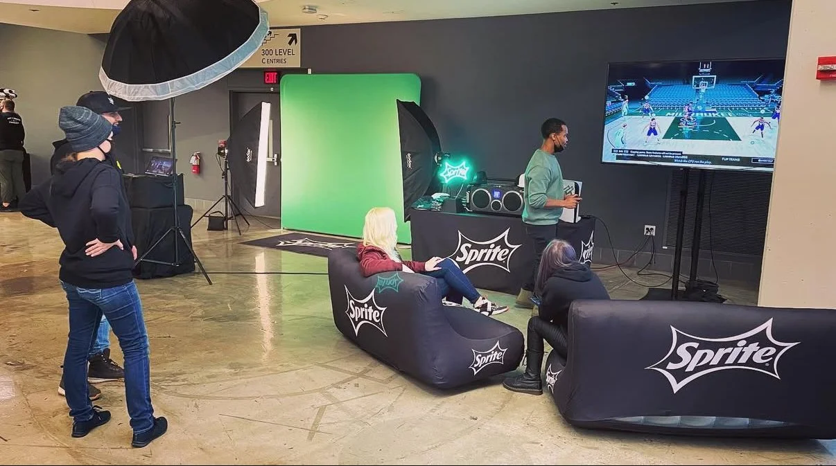 Interactive Sprite branded green screen photo booth activation with inflatable couches, lighting equipment, and video screens.