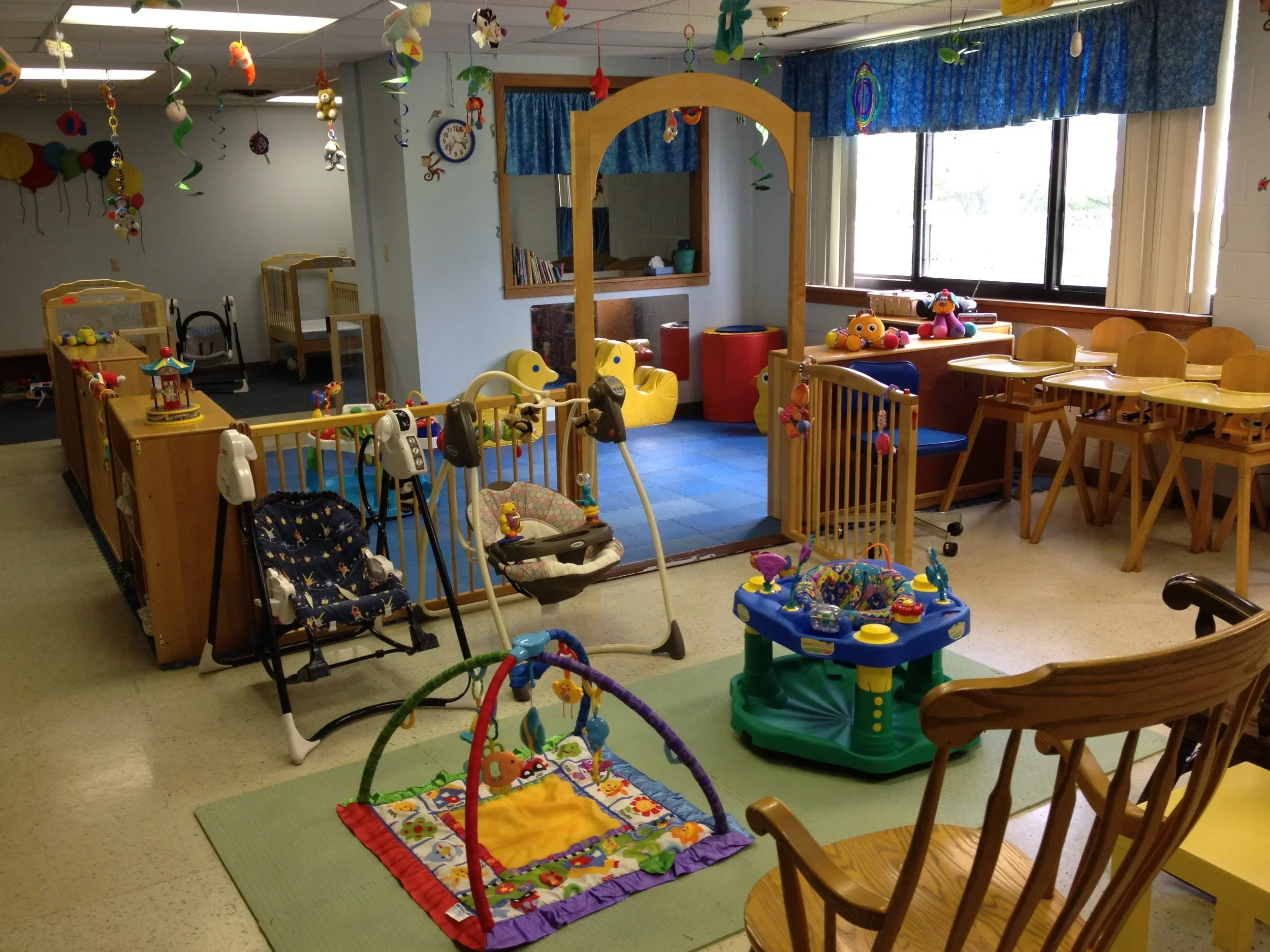 Infant receiving care from a teacher at Twelve Corners Day Care Center