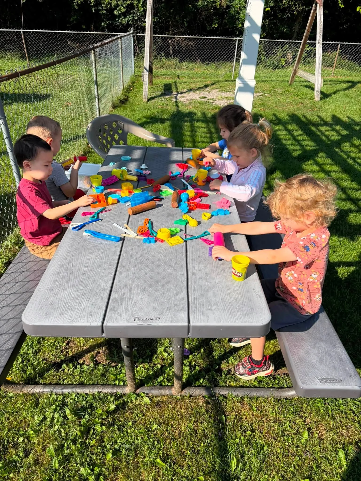 Toddlers enjoying outdoor play at Twelve Corners Day Care Center