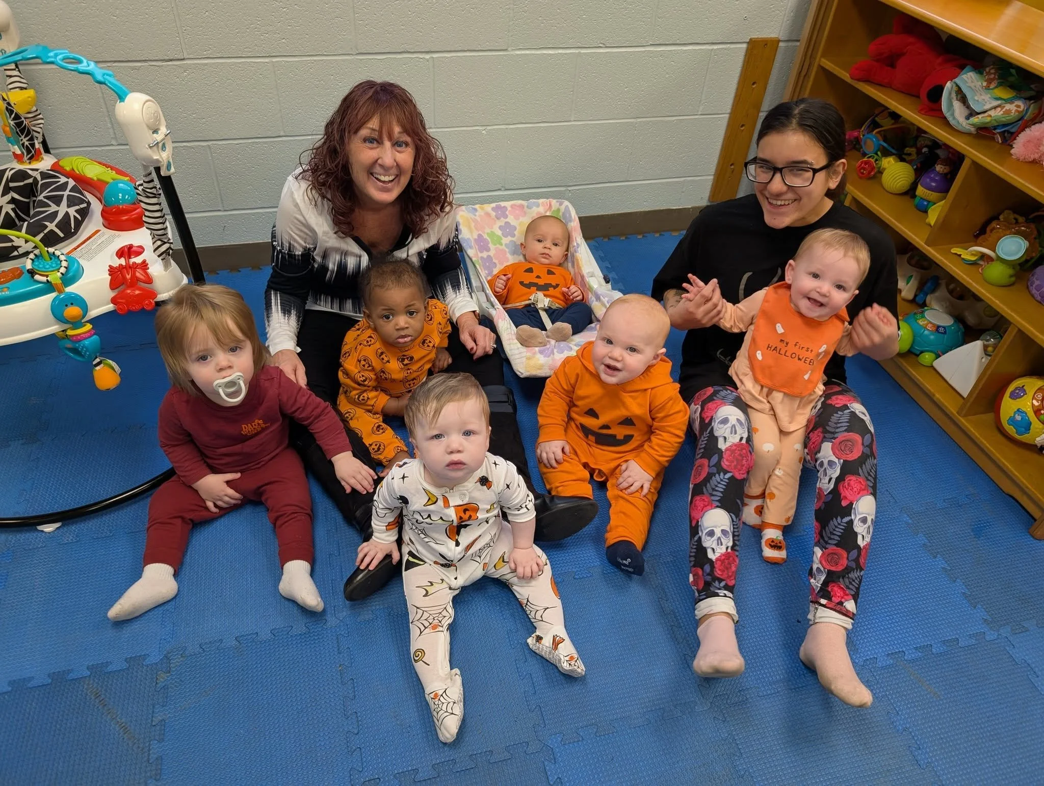 Teachers providing individualized care to an infant at Twelve Corners Day Care Center