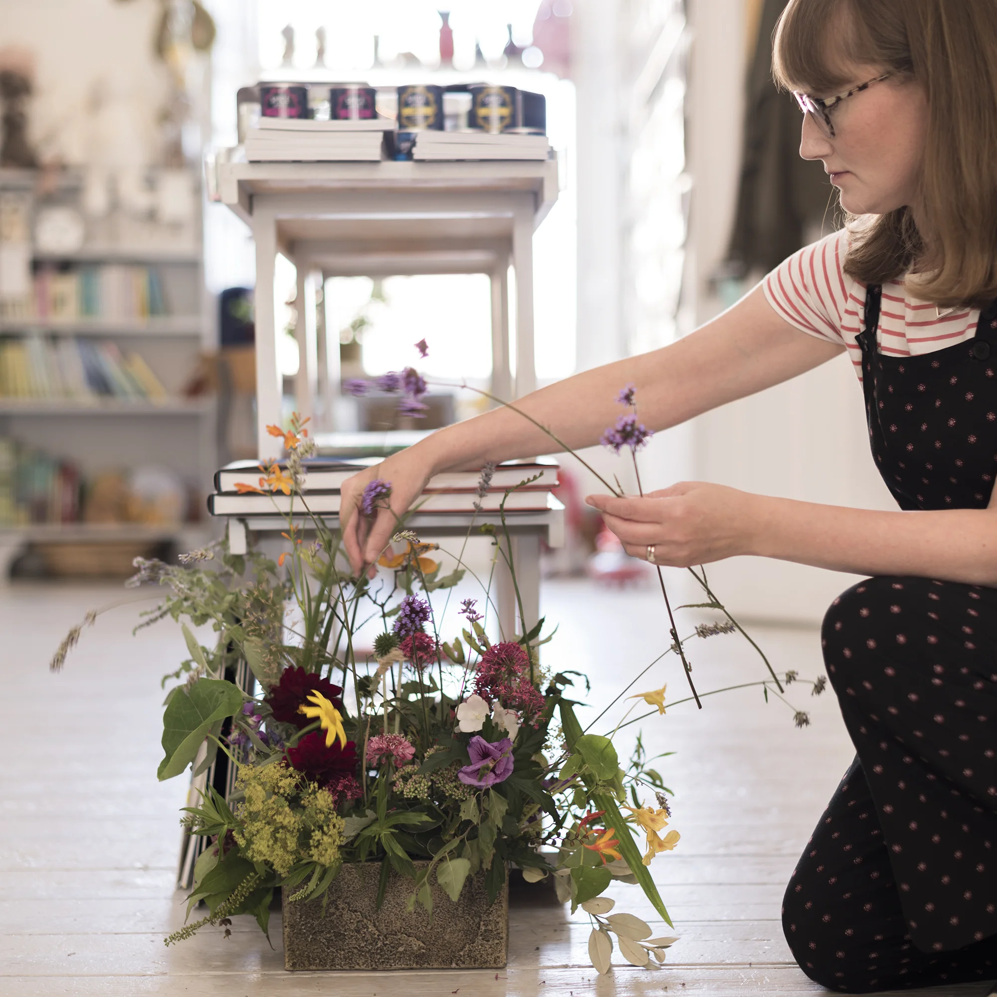 Jen Bell Harman arranging locally sourced flowers inside Cove