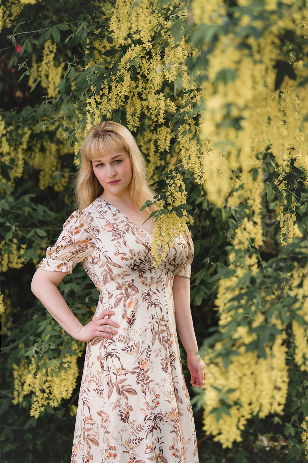 College Senior Pictures_graduation photo of blonde girl in floral dress in yellow flowers_Studio B Portraits_Nelson_4477.jpg
