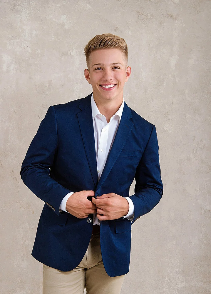 High School senior boy in navy blue suit and khaki pants.jpg