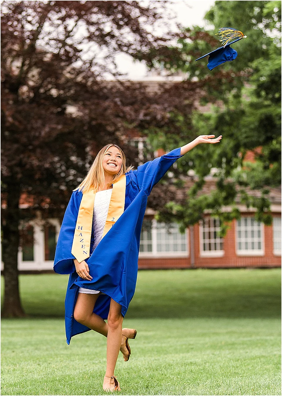 We love Erin’s sweet little white dress that she wore underneath her graduation gown as a peek a boo to her savvy fashion sense! | pc: StudioBportraits.com