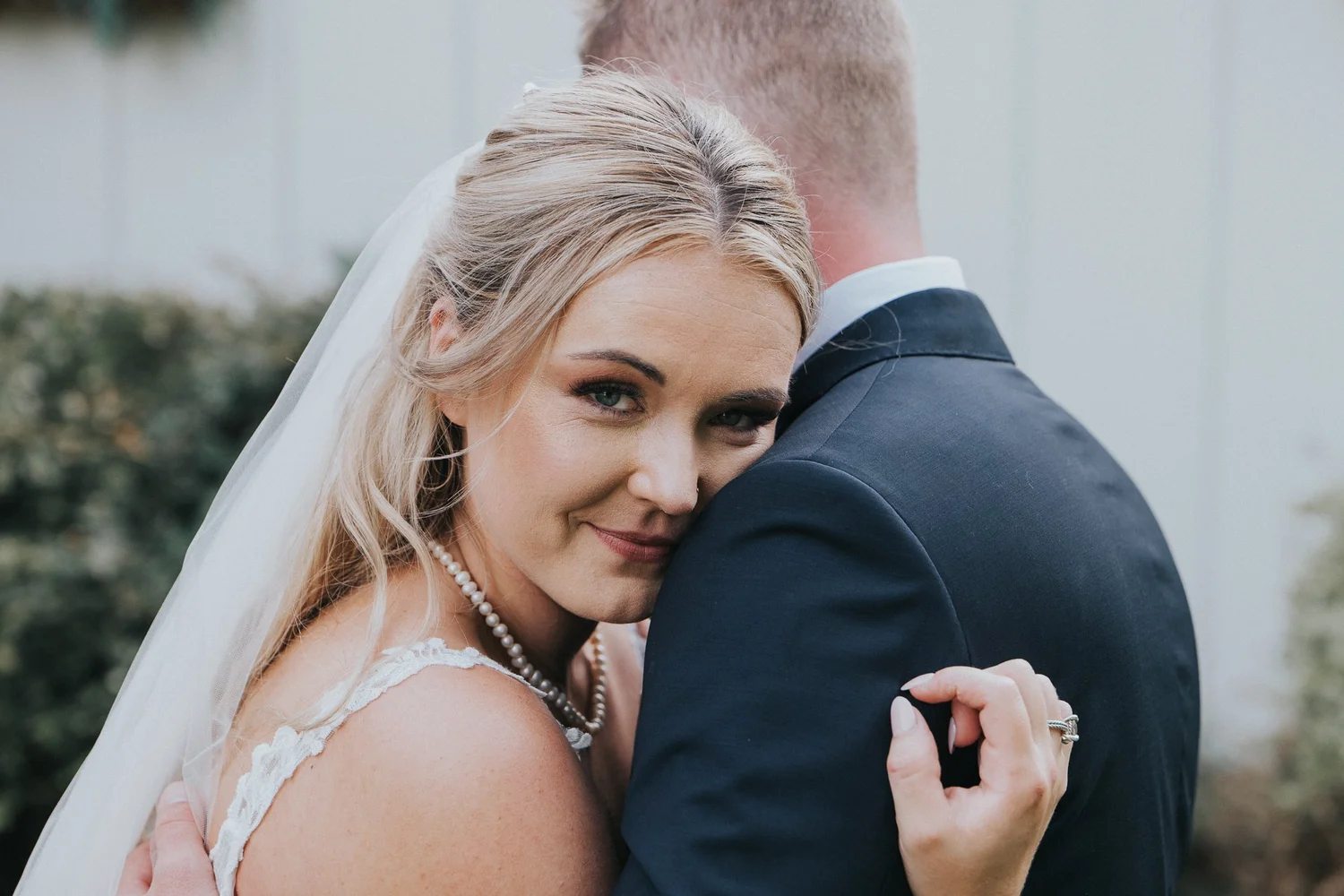 Bride resting her head on her groom's shoulder